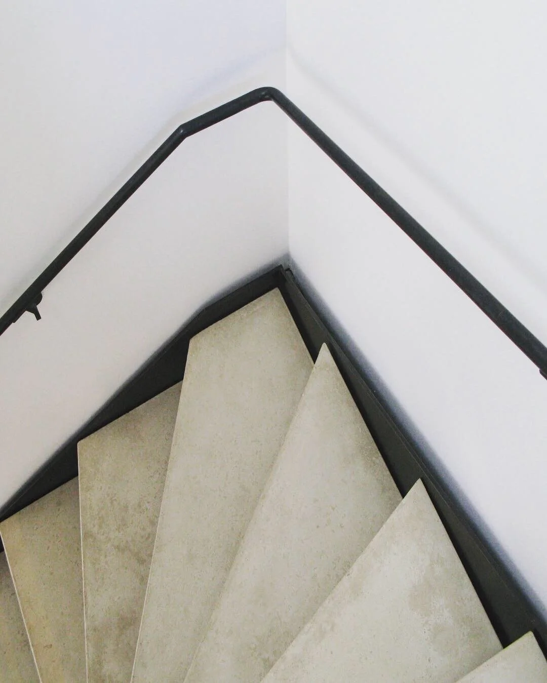Winding steel frame stair and hand rail, with concrete treads.