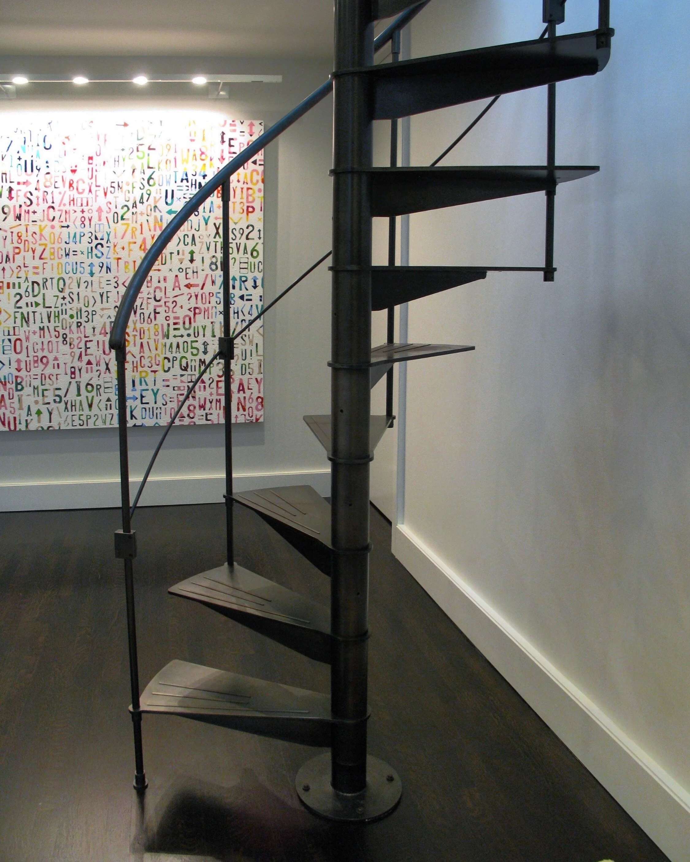 Steel spiral stair with handrail.  machined steel treads