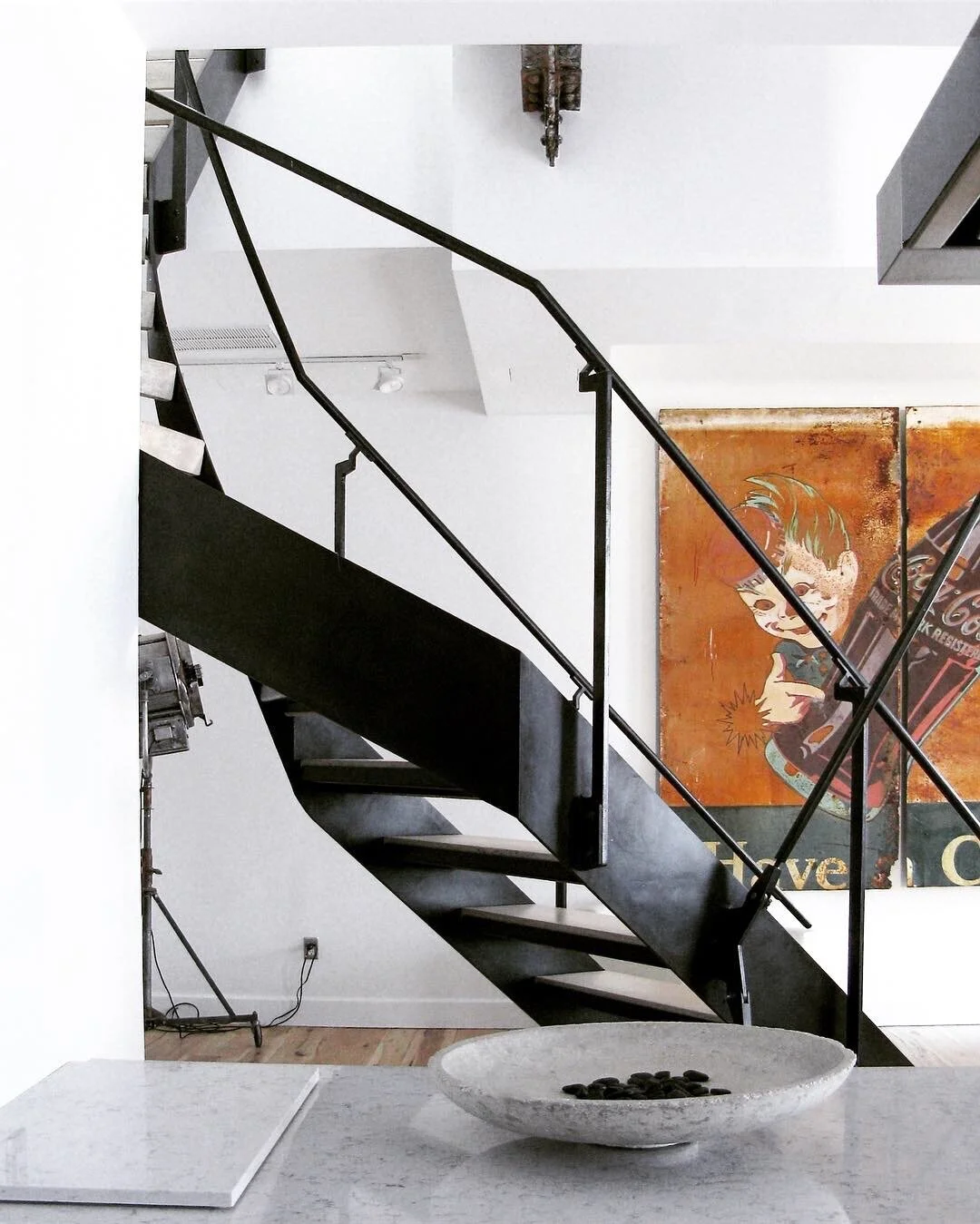 Winding steel frame stair and hand rail, with concrete treads.