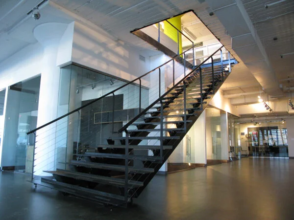 Steel frame stair and handrail.  Concrete treads and stainless steel infill
