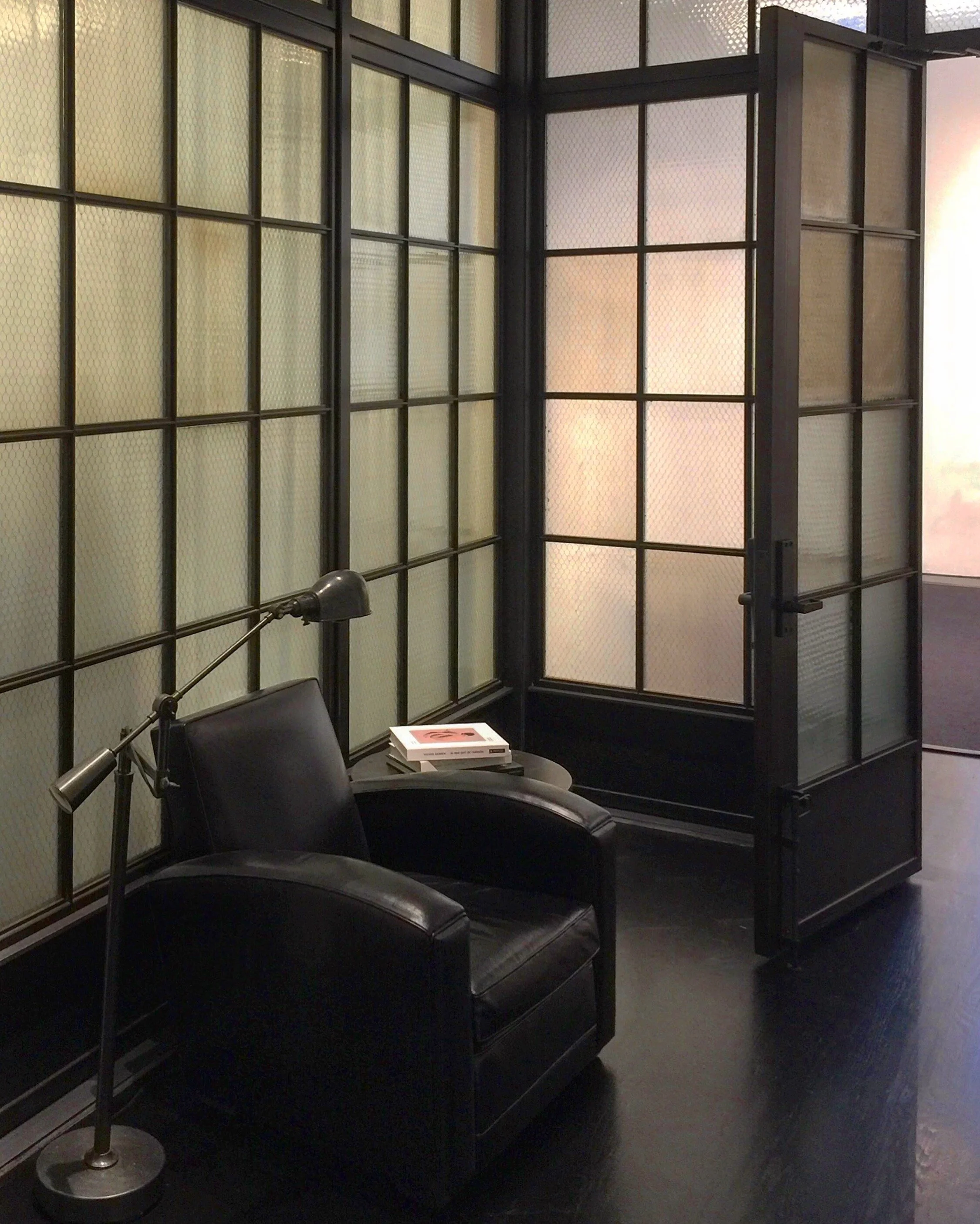 Steel and Glass partition with french style doors.  Infill is vintage factory textured wire glass