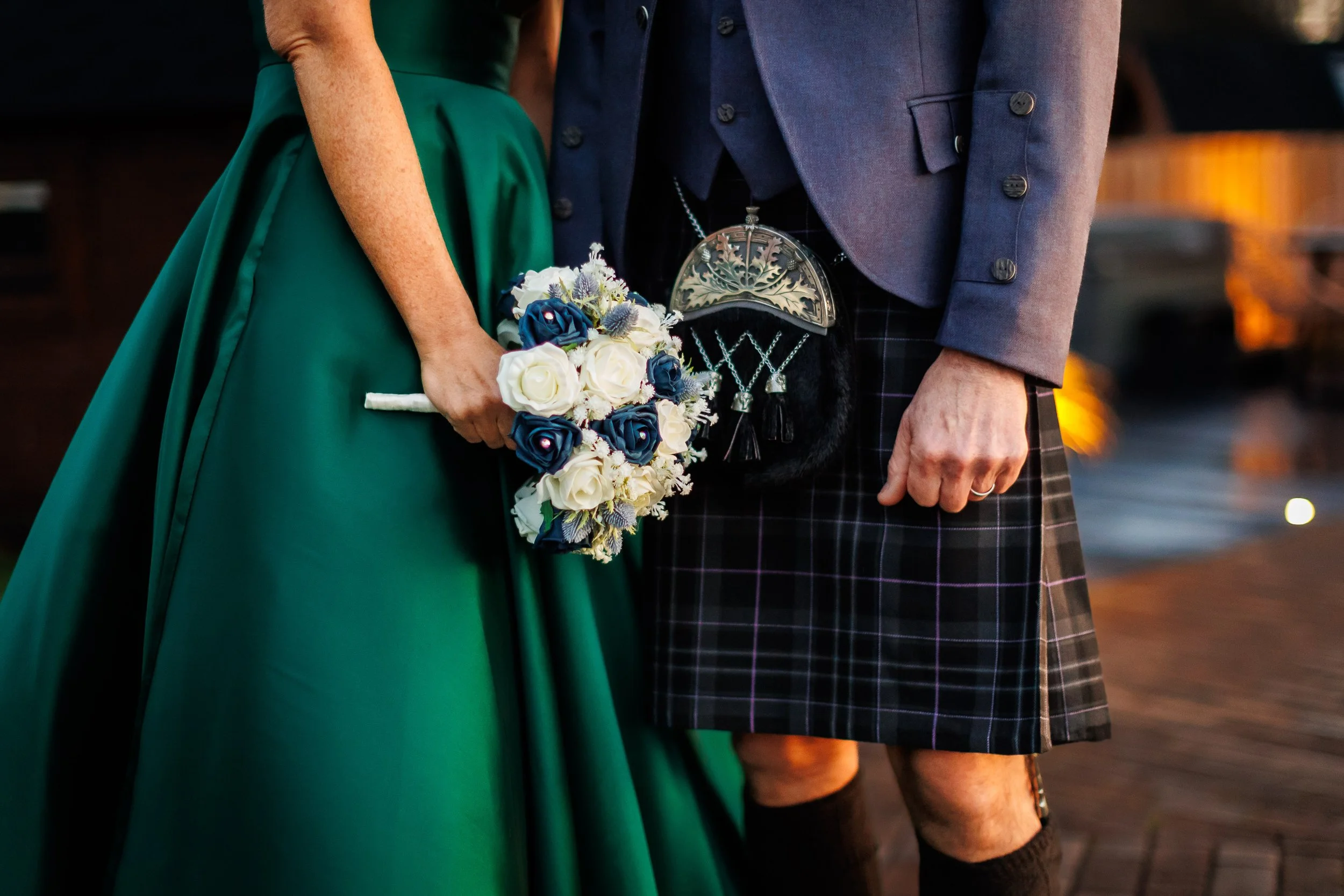 Wedding bouquet and kilt detail.