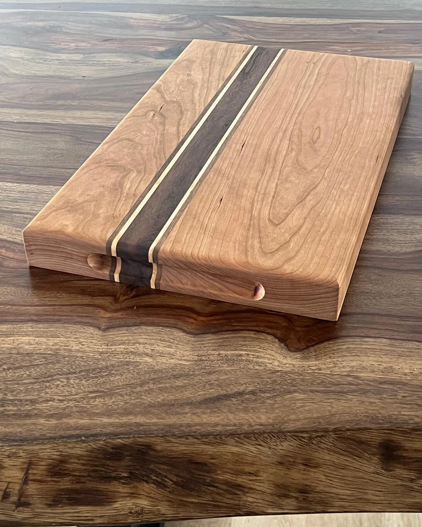 11x18 cherry, maple, walnut cutting board. 
Been messing around with cutting boards lately. Stay put, more designs to come!