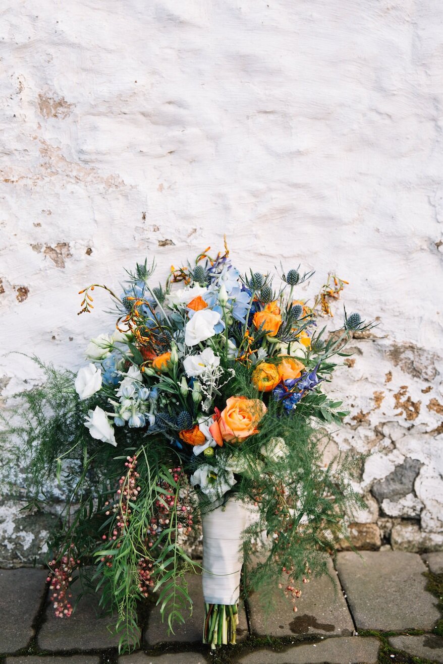 Bridal Bouquet inspired by a winter fairytale wedding with blue hues and orange accents.