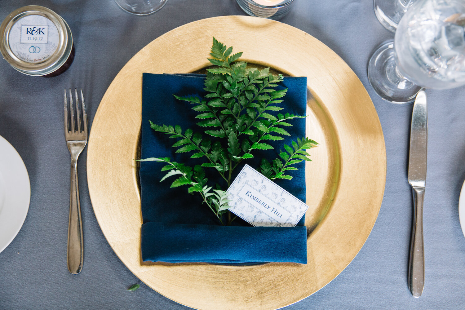 Simple fern accent on a gold charger plate.