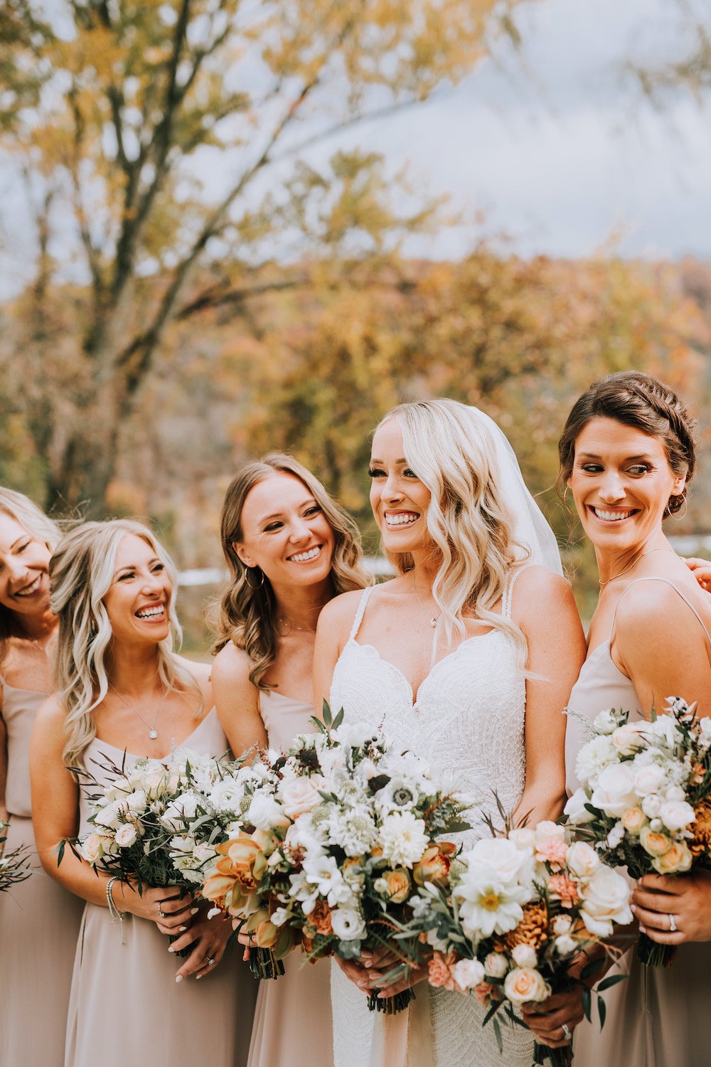 Bride with Bridesmaids laughing 