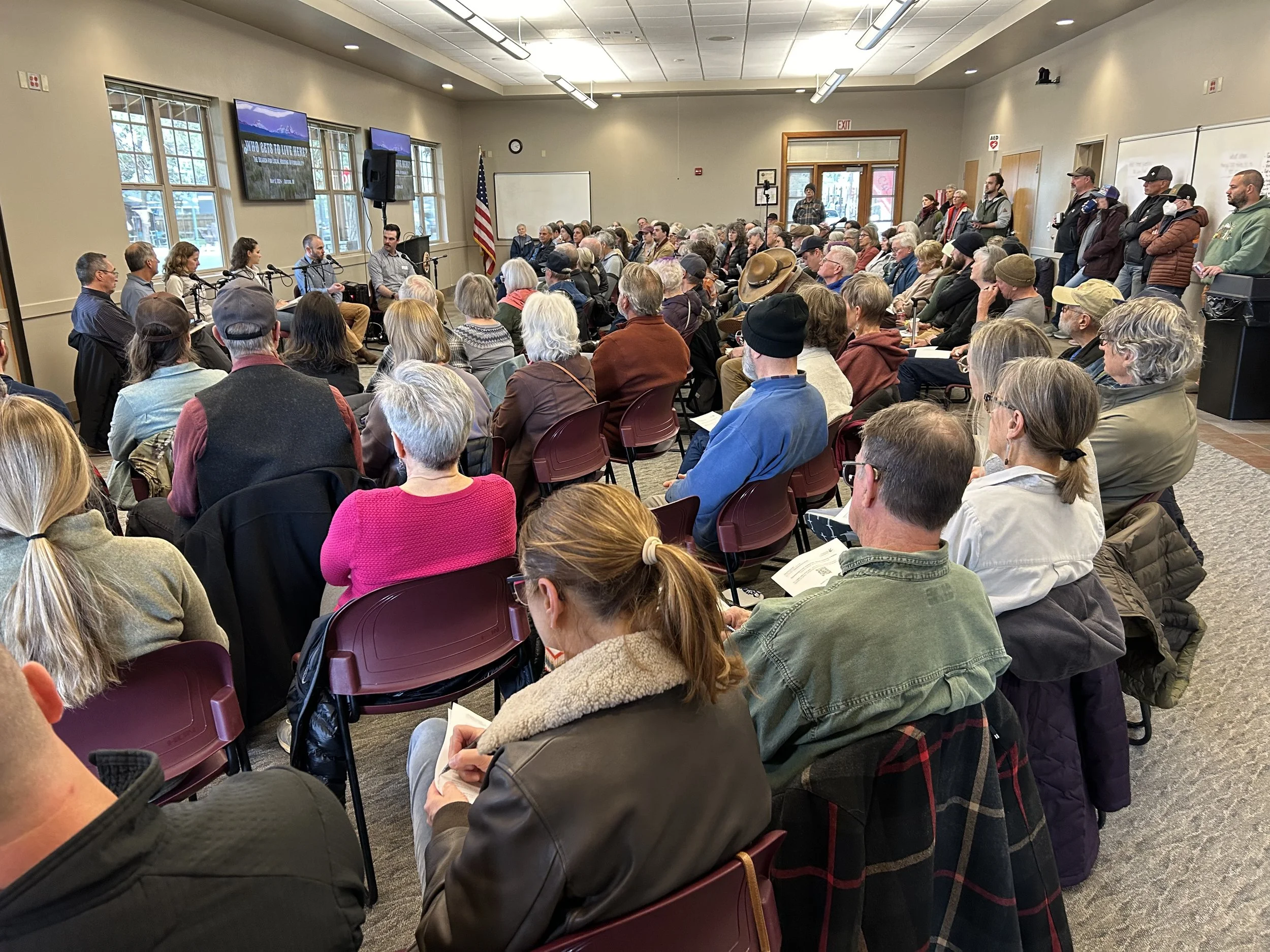 A community forum with residents seated for discussion
