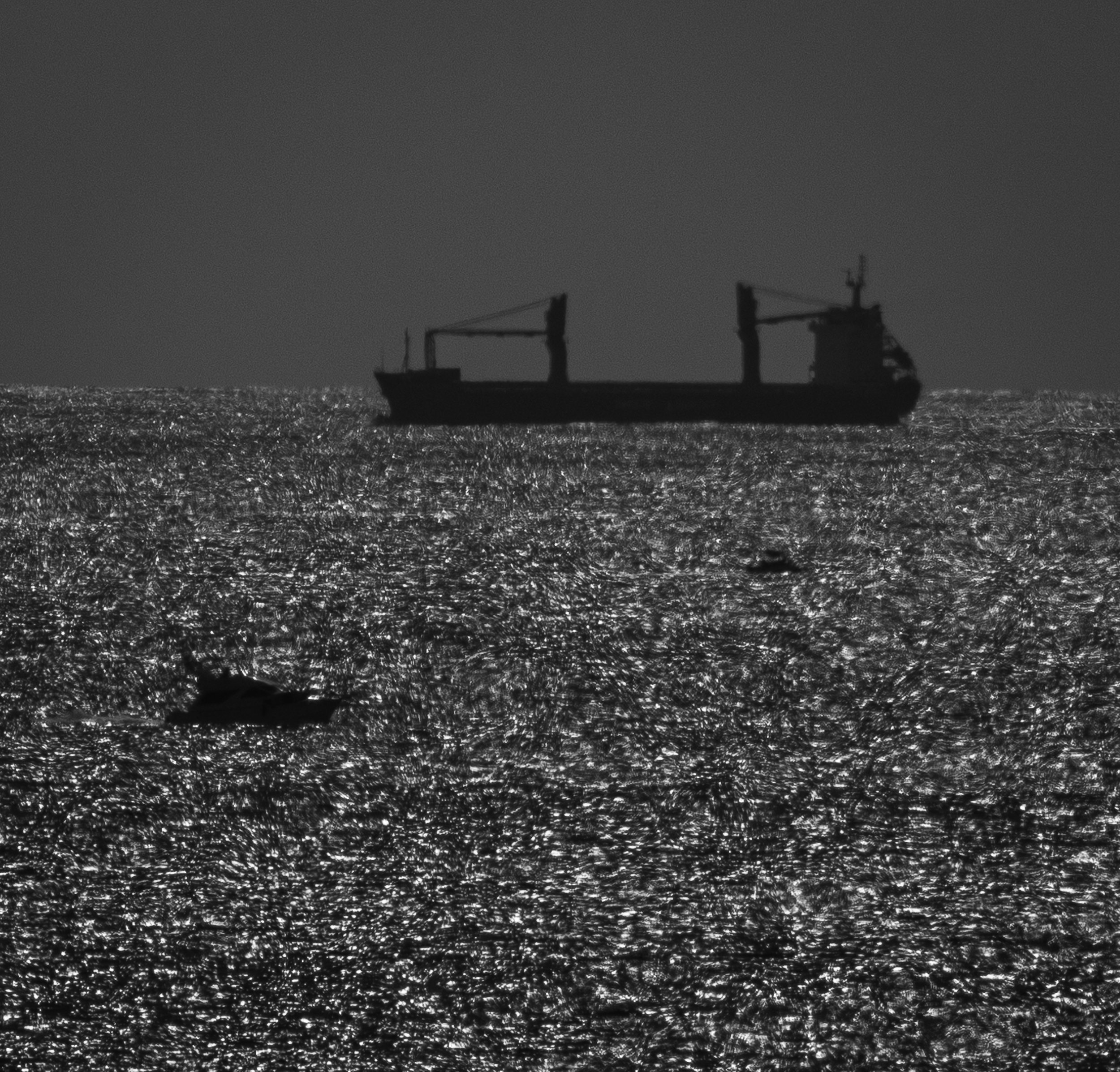 Dark ship on a silver ocean