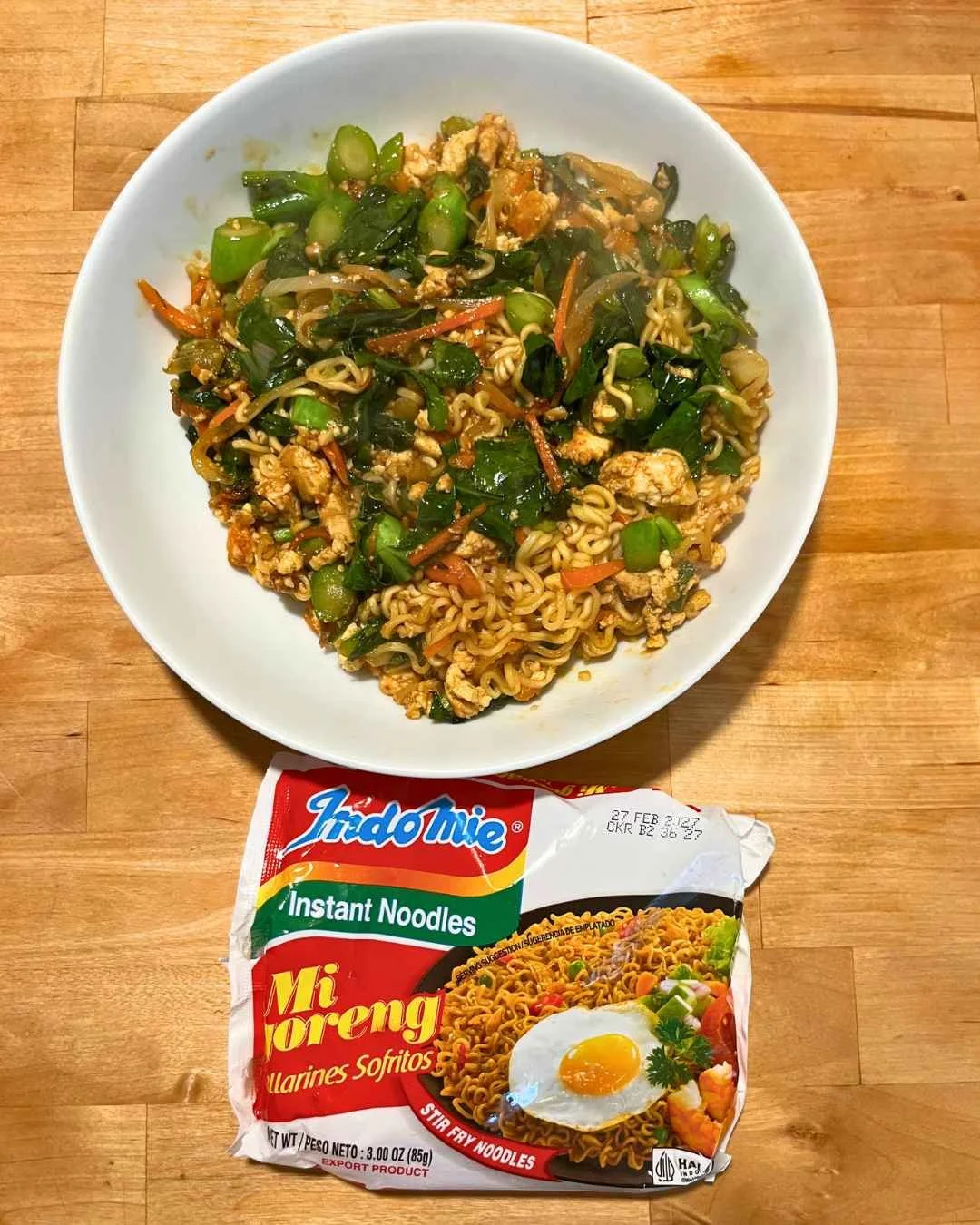 Stir-frying Pad See Ew instant noodles with vegetables and fried tofu in a wok