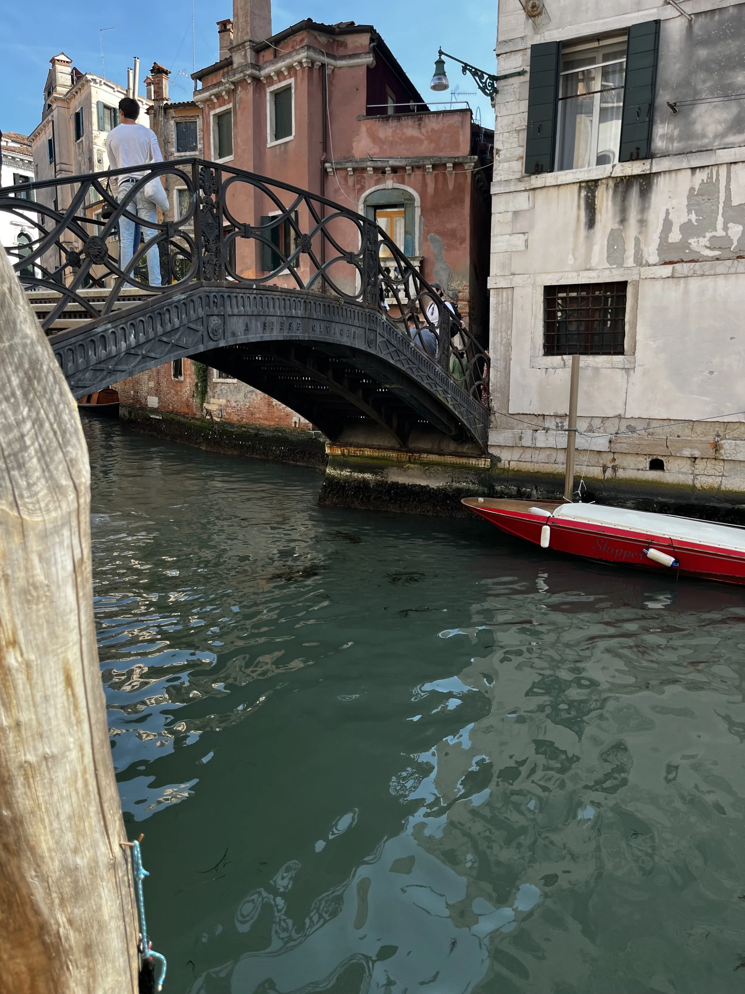 Iron footbridge over a quiet canal in Venice Italy
