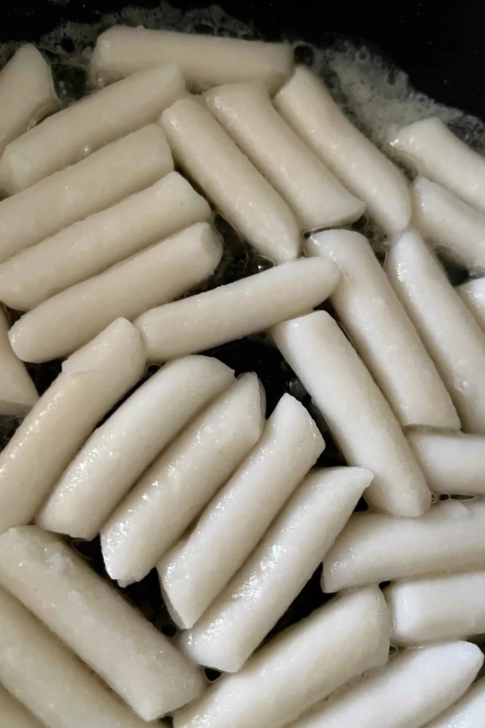 rice cakes added to the pan, picking up color
