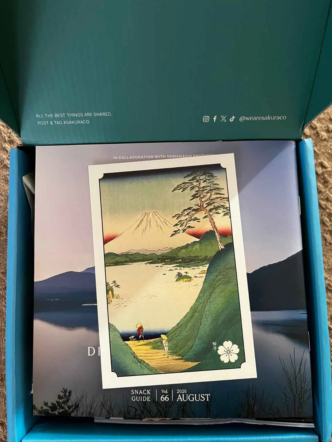 Sakuraco Discovering Mt. Fuji box open with ukiyo-e postcard and Vol. 66 snack guide