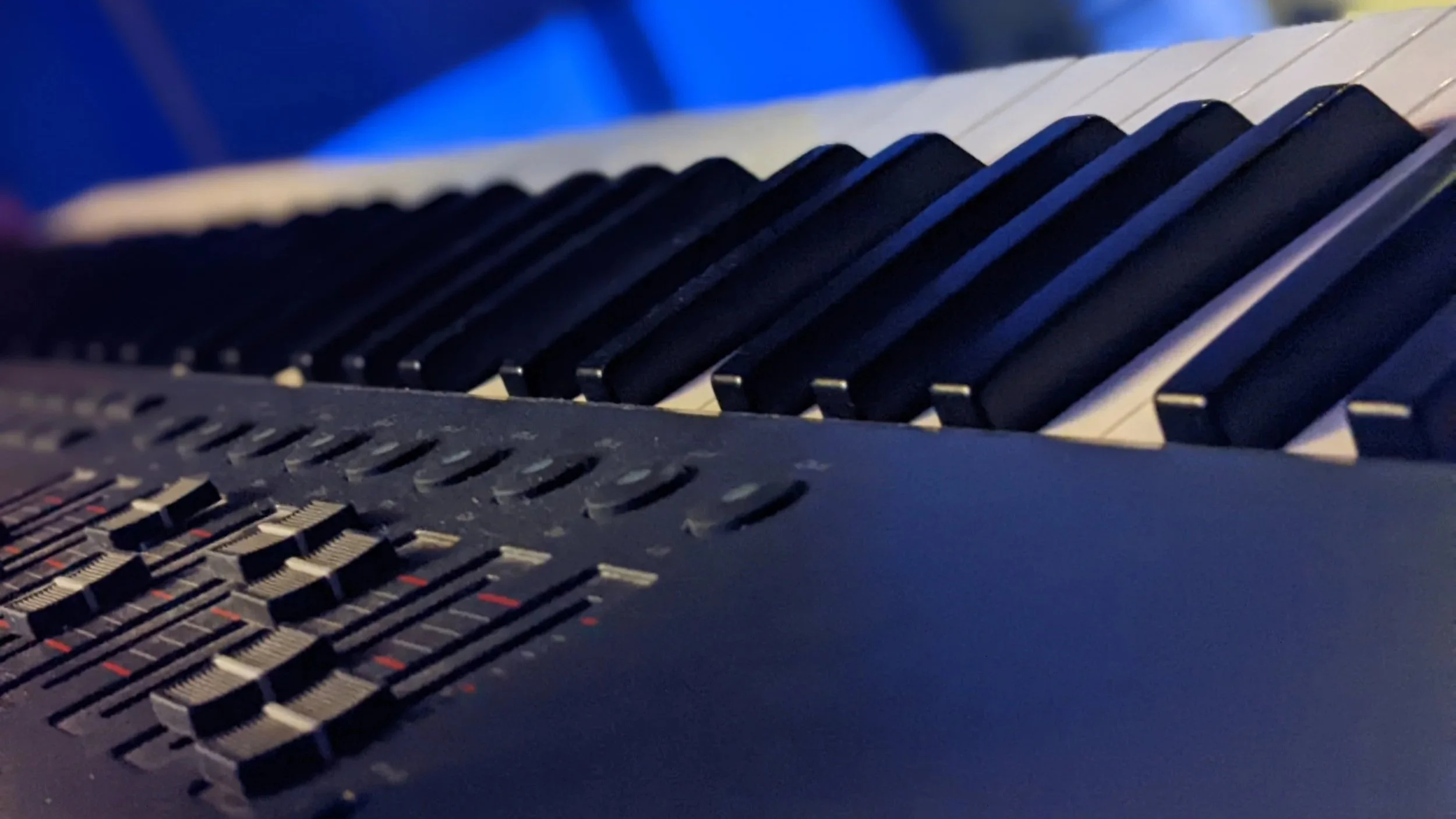 Close-up of a music keyboard and production controller used for creating original instrumental music.