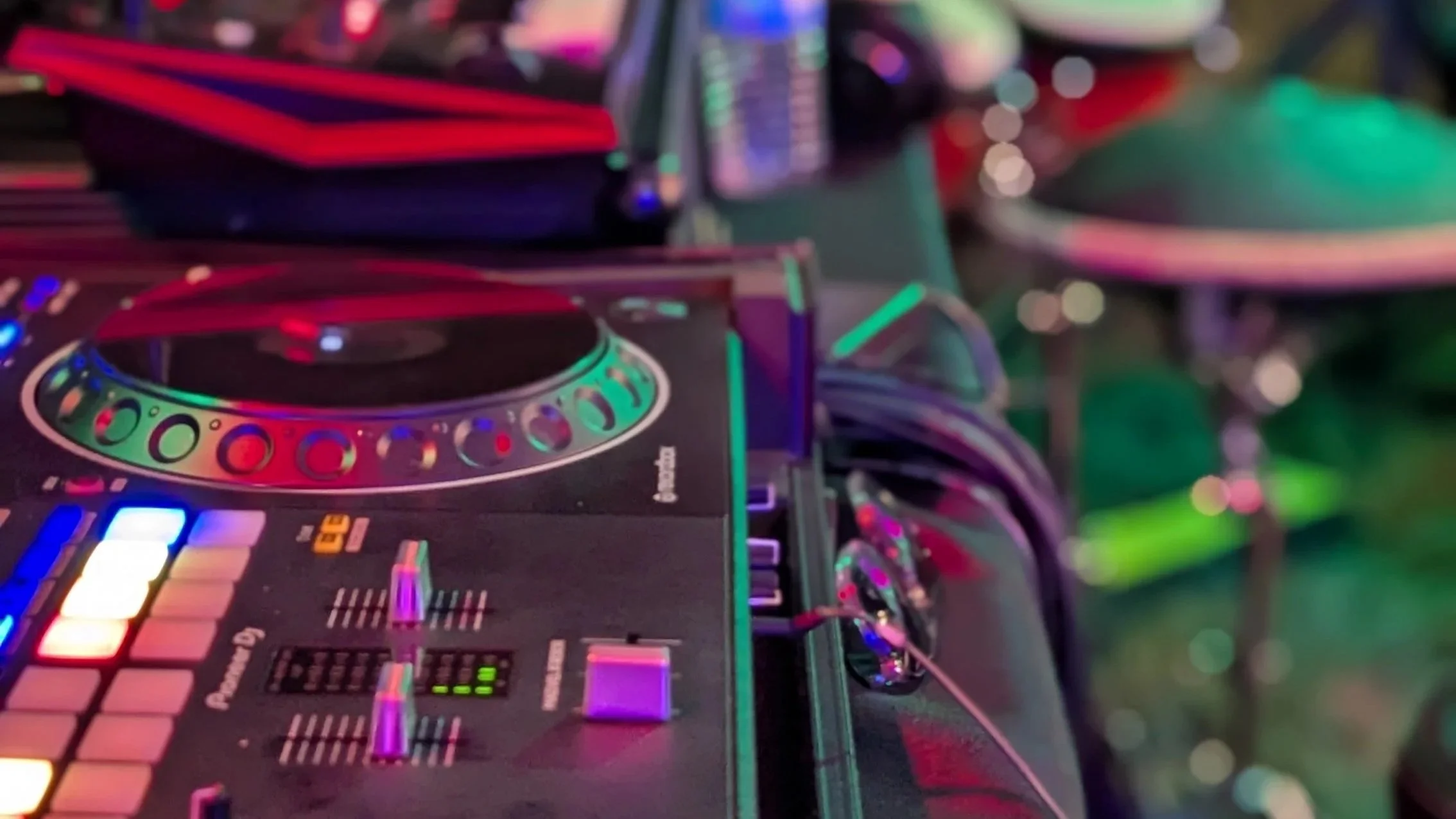 Professional DJ controller and turntable setup with illuminated performance controls.