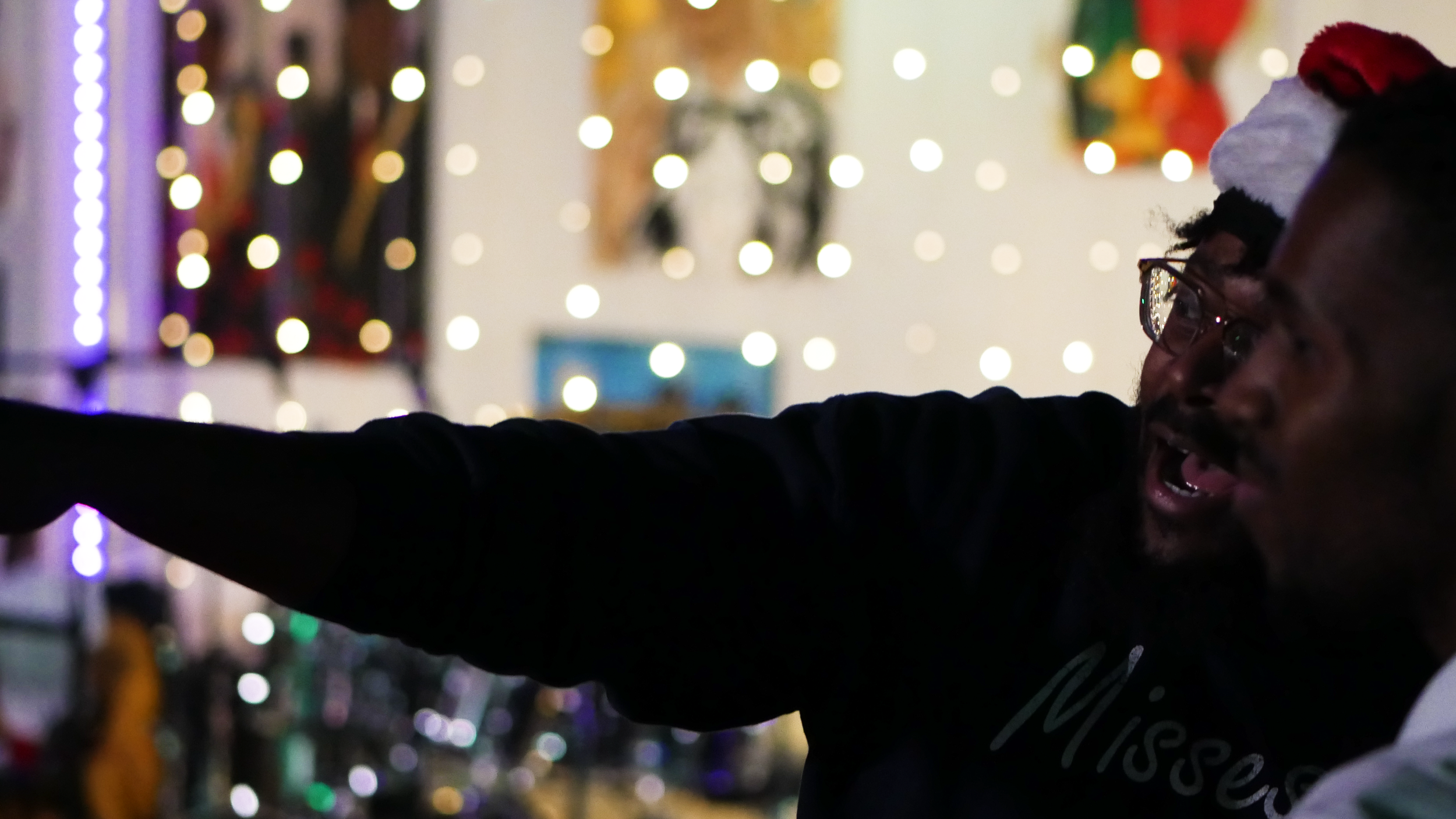 Event production crew member working on site during a live event with stage lighting in the background.