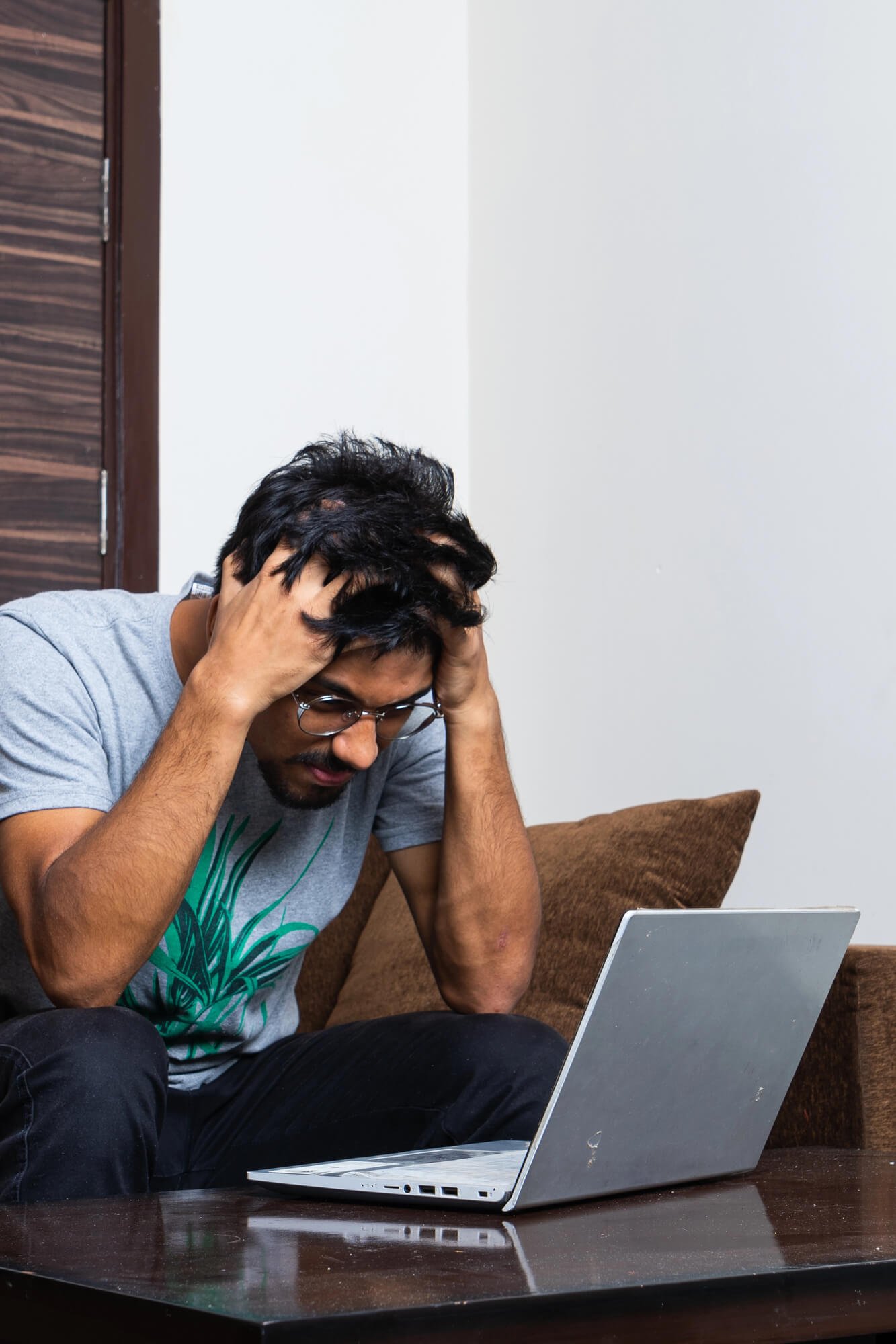 Man experiencing anxiety and emotional stress while working, representing anxiety therapy in Atlanta and Dunwoody, GA