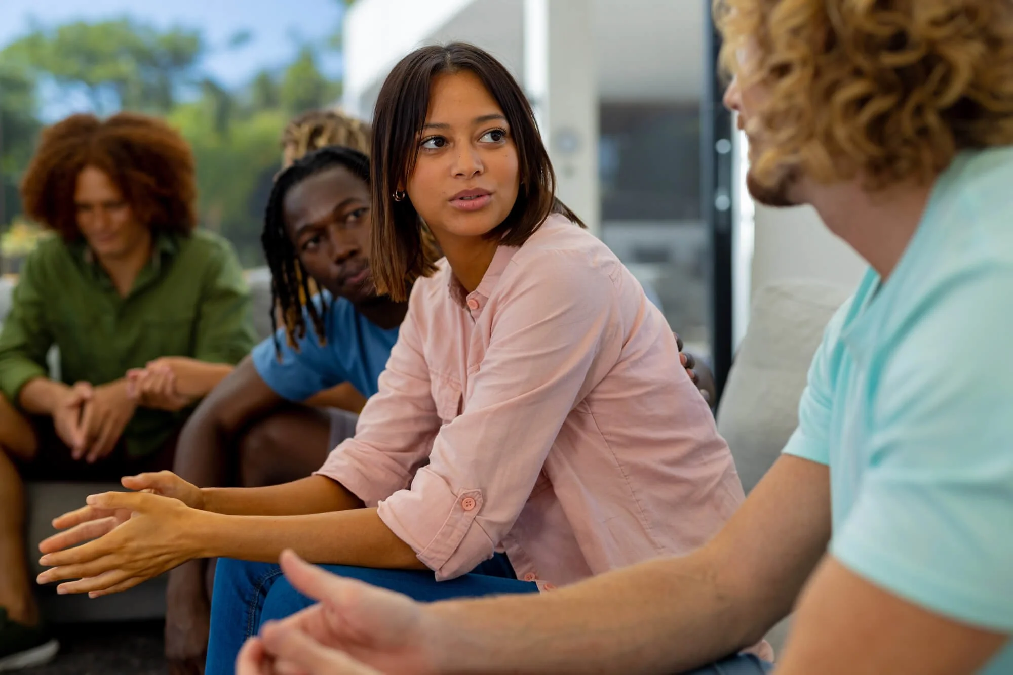 Diverse adults participating in a supportive group counseling session in Dunwoody, Georgia