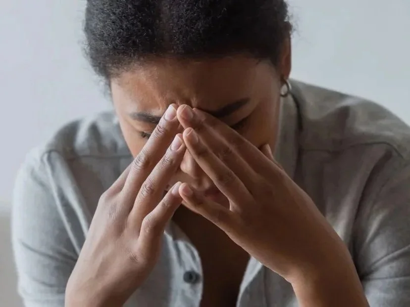 Woman working thoughtfully in a professional setting, representing individual counseling and personal growth in Dunwoody