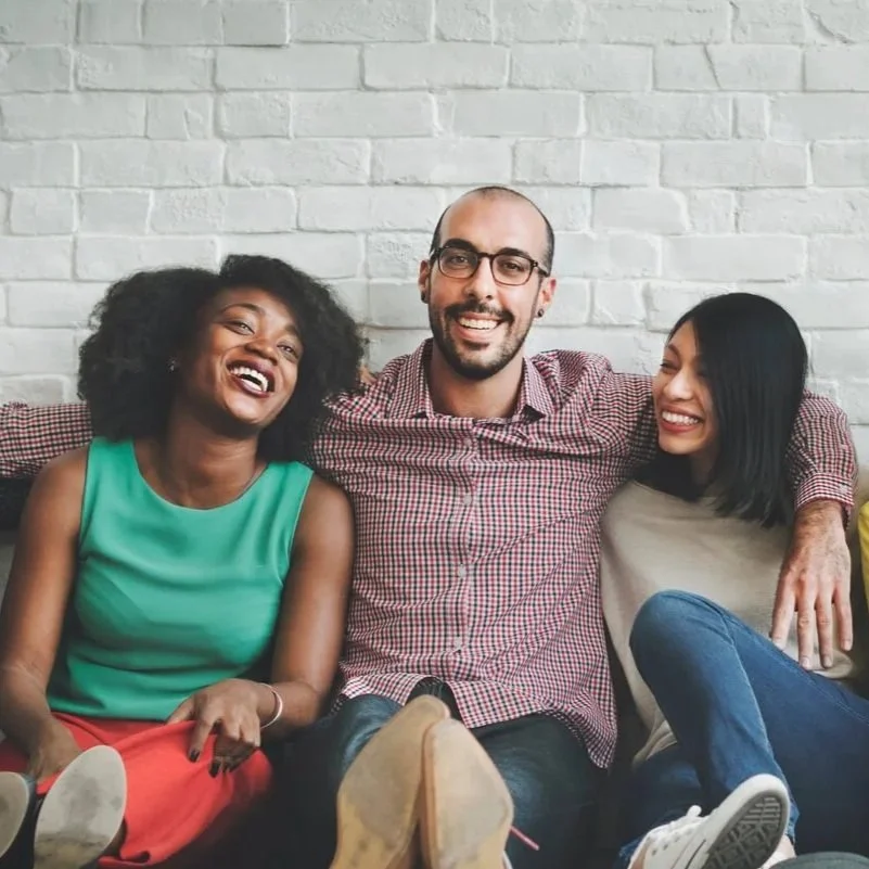 Diverse group of adults smiling together, representing culturally responsive BIPOC counseling and therapy services in Dunwoody