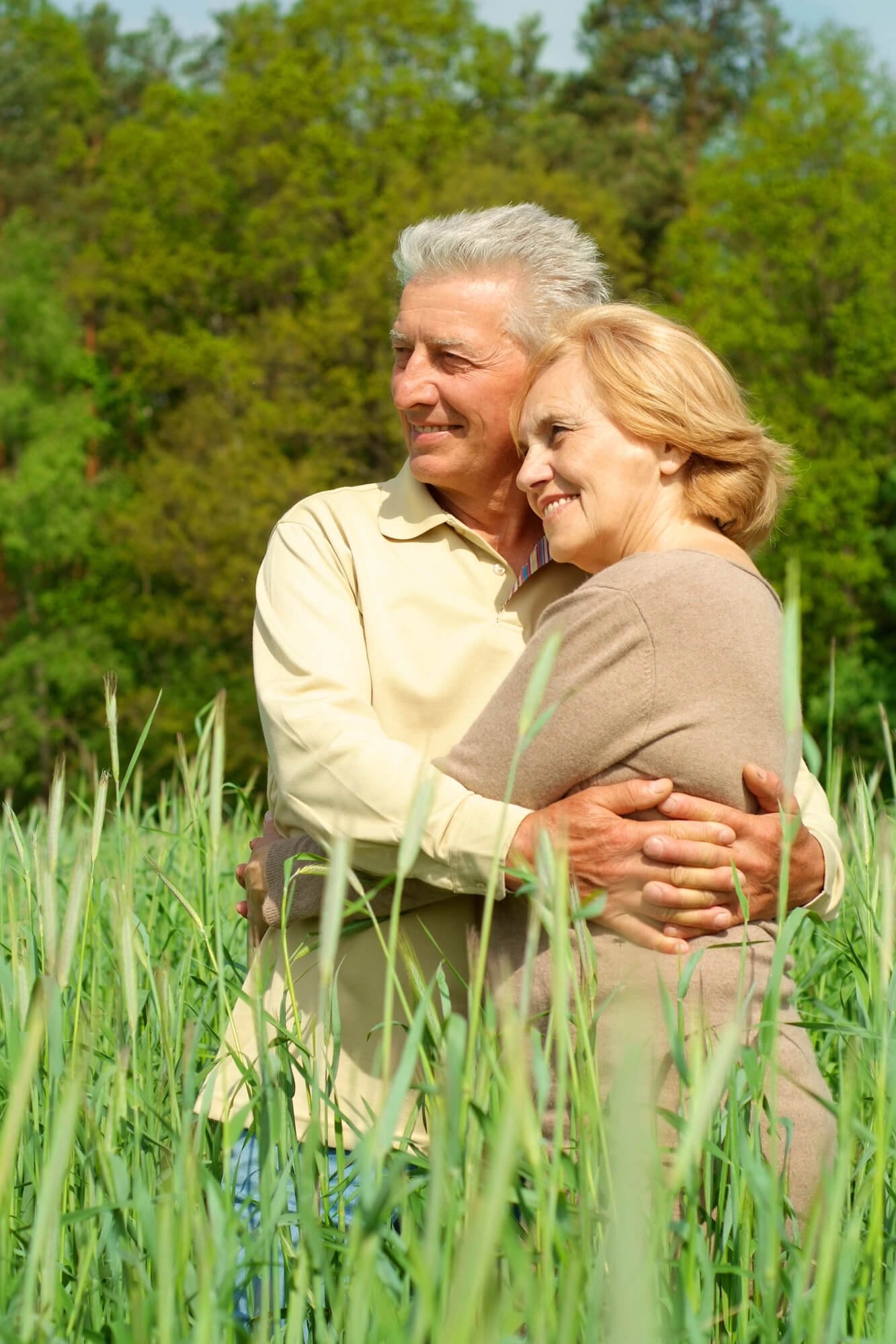 Older married couple embracing outdoors, representing marriage counseling in Atlanta and Dunwoody, GA.