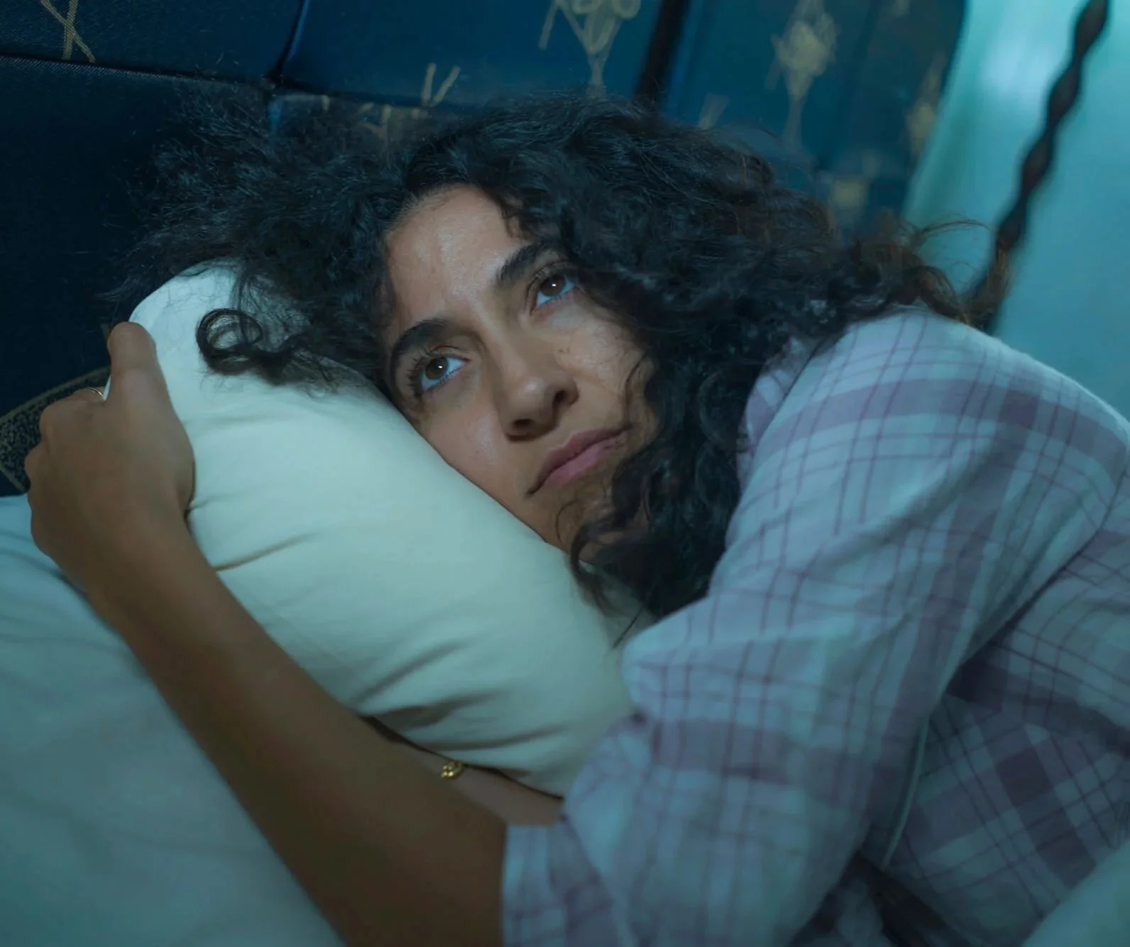 Woman lying awake in bed feeling low and unable to sleep, representing symptoms addressed in depression therapy in Atlanta.