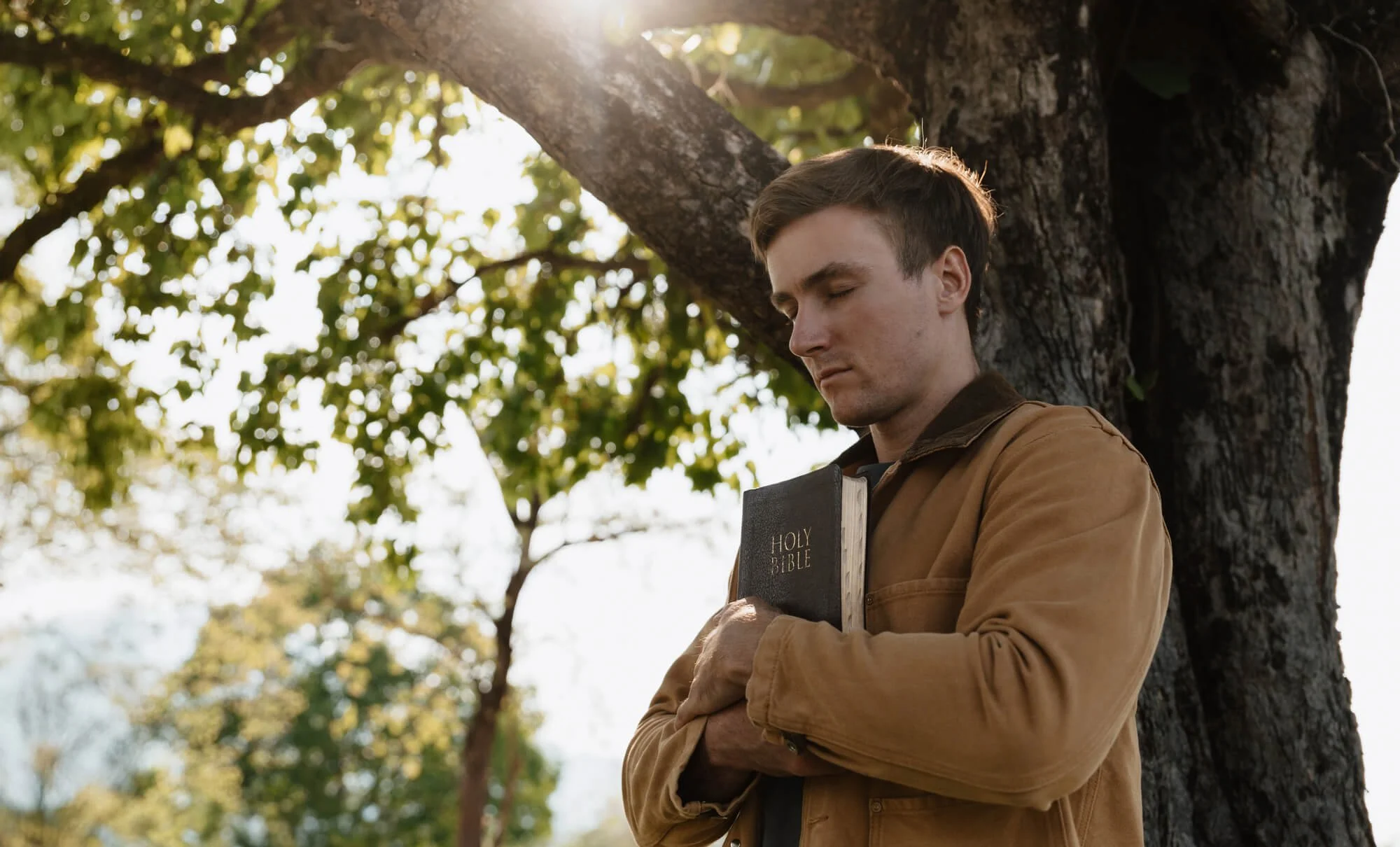 Man holding a Bible in quiet reflection, representing faith-based spirituality counseling in Atlanta and Dunwoody, GA.