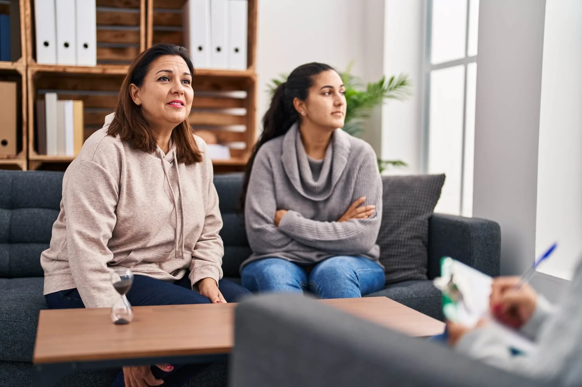 Two women meeting with a therapist during a sliding scale therapy session in Atlanta.