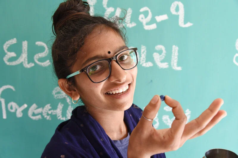  Adolescent girls taking IFA Blue tablet at Gandhar AWC. 