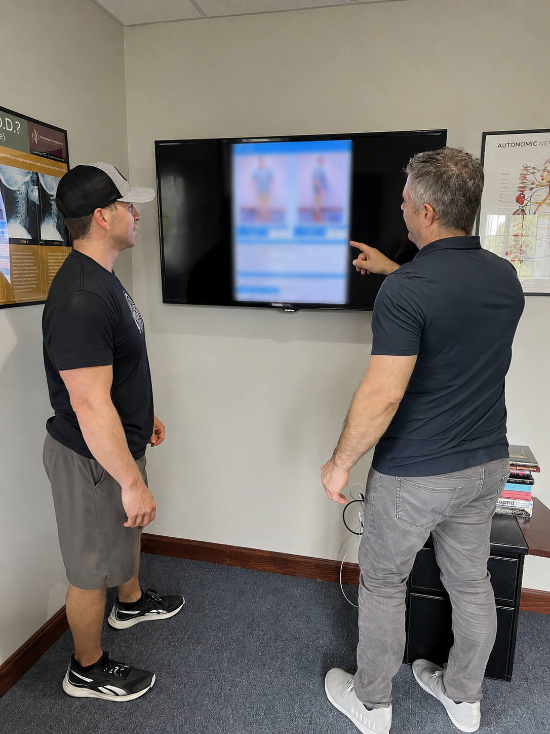 Dr Olivieri reviewing findings with a patient with a sports injury