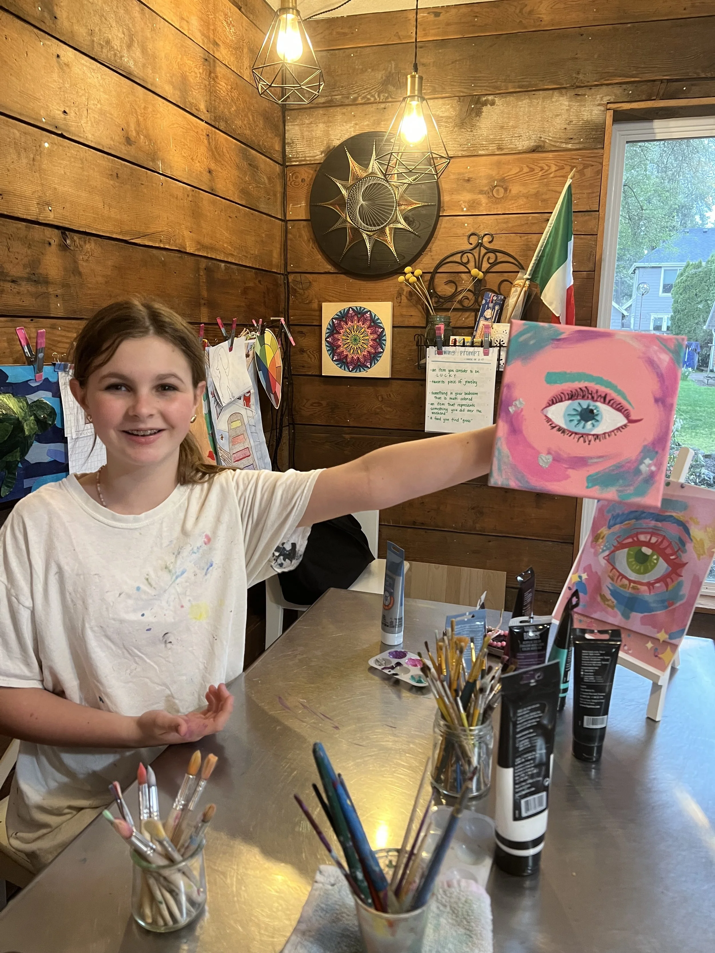 Ada holding her eye painting.jpeg