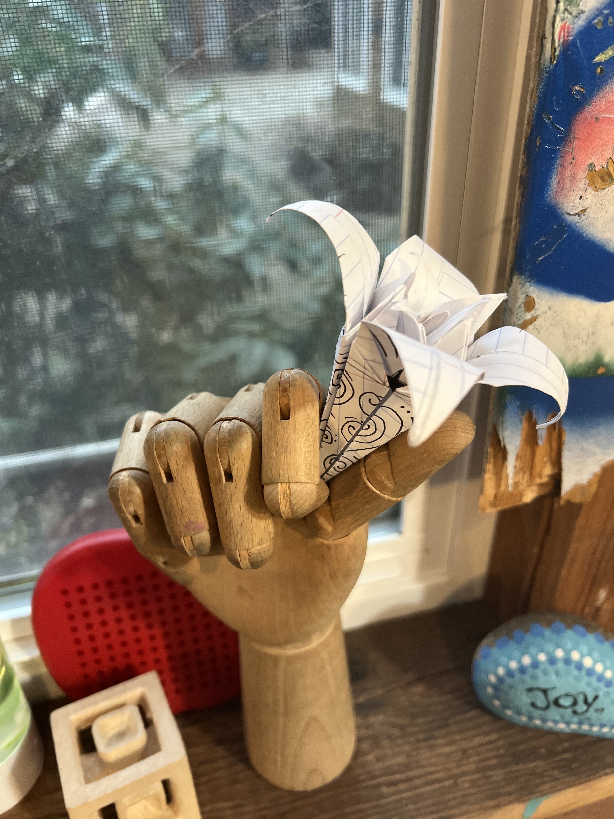 manniquin handi with a paper lily.jpeg