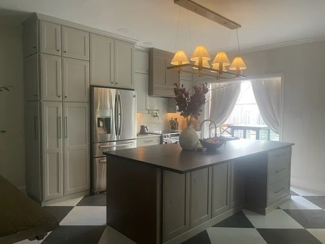 Sage Cabinetry in Dallas Townhome Kitchen with black leathered island countertop