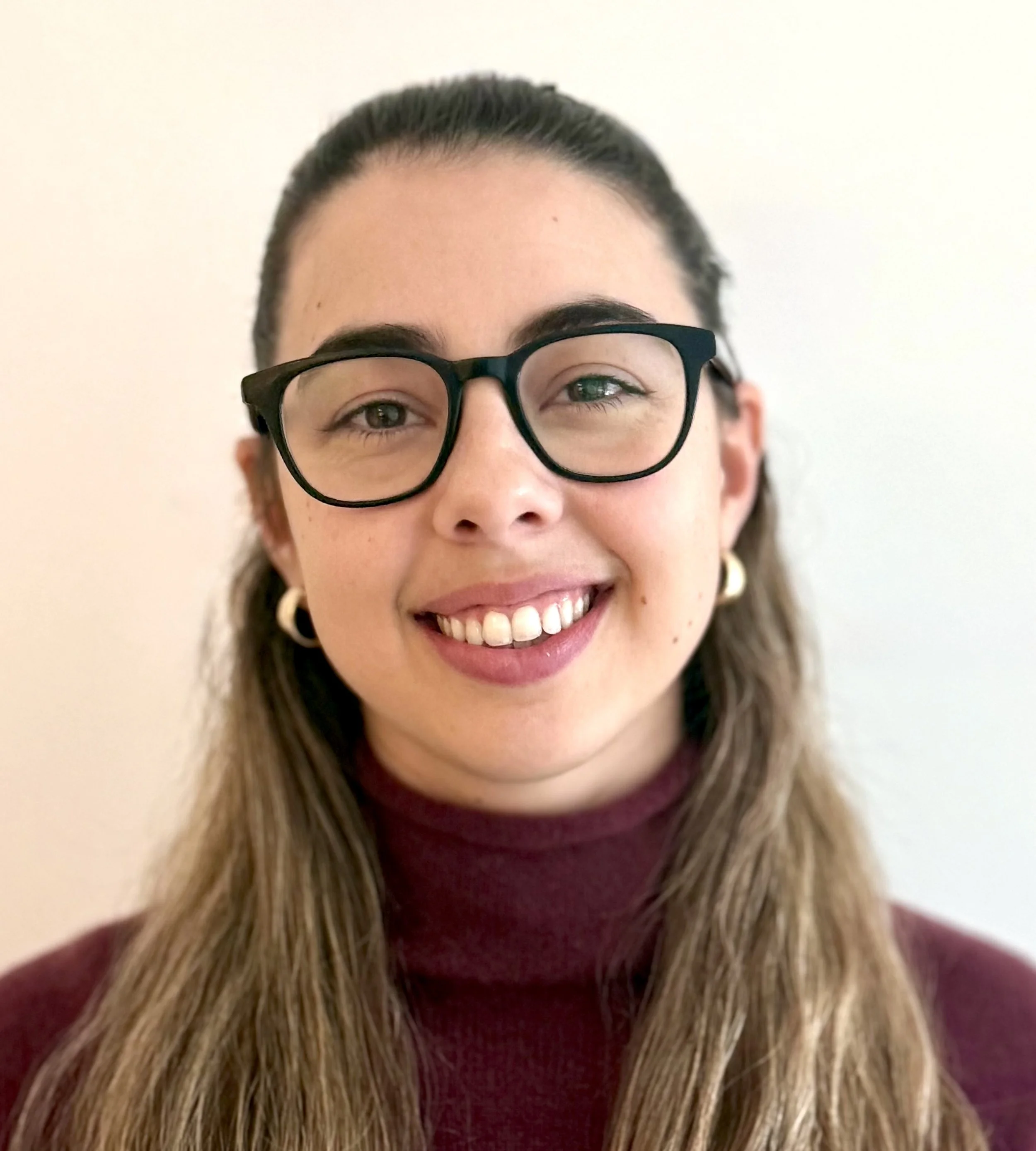 Headshot of a female lawyer with glasses.