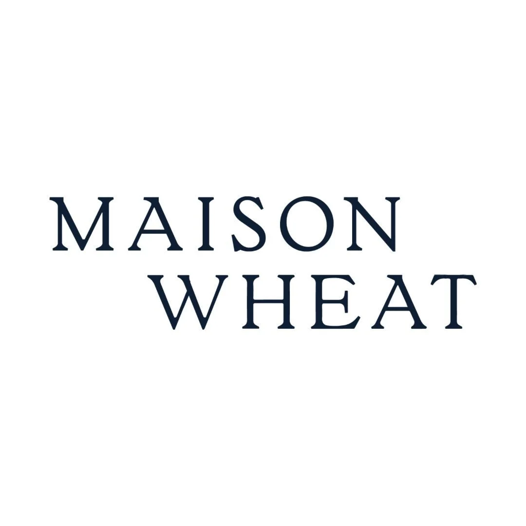 Maison Wheat logo with navy blue text on white background.  Luxury fashion retailer.