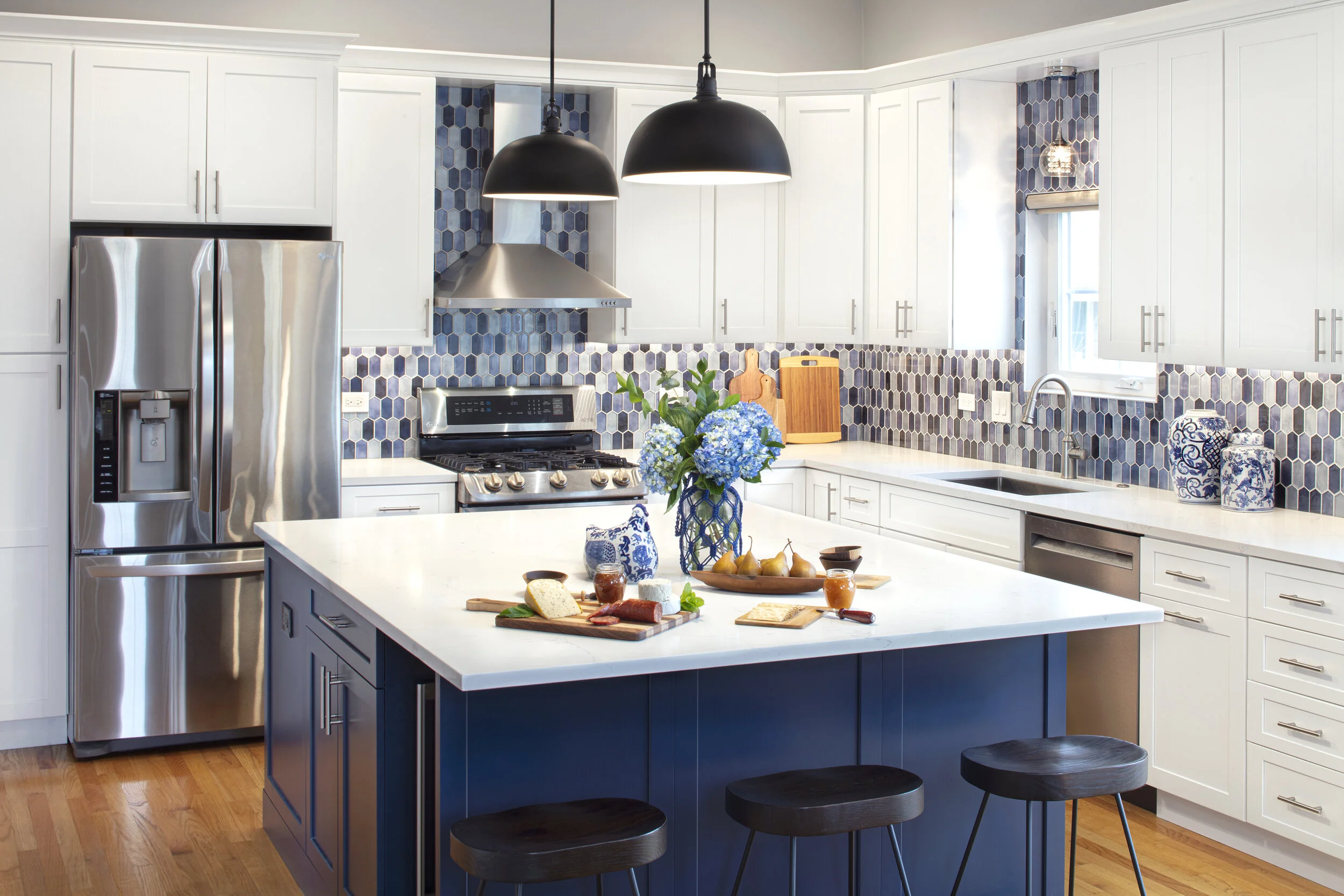 Blue and White Kitchen with large island by Adam Zollinger Interiors