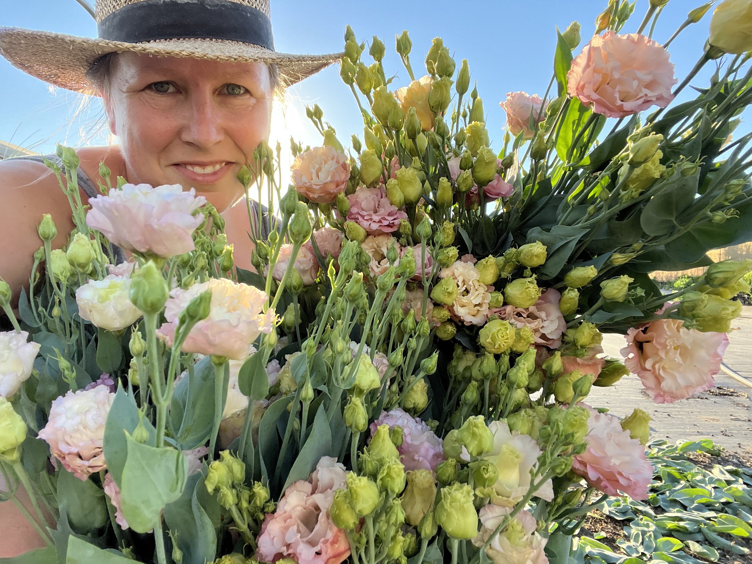 selfie with a large bouquet of pink and green flowers