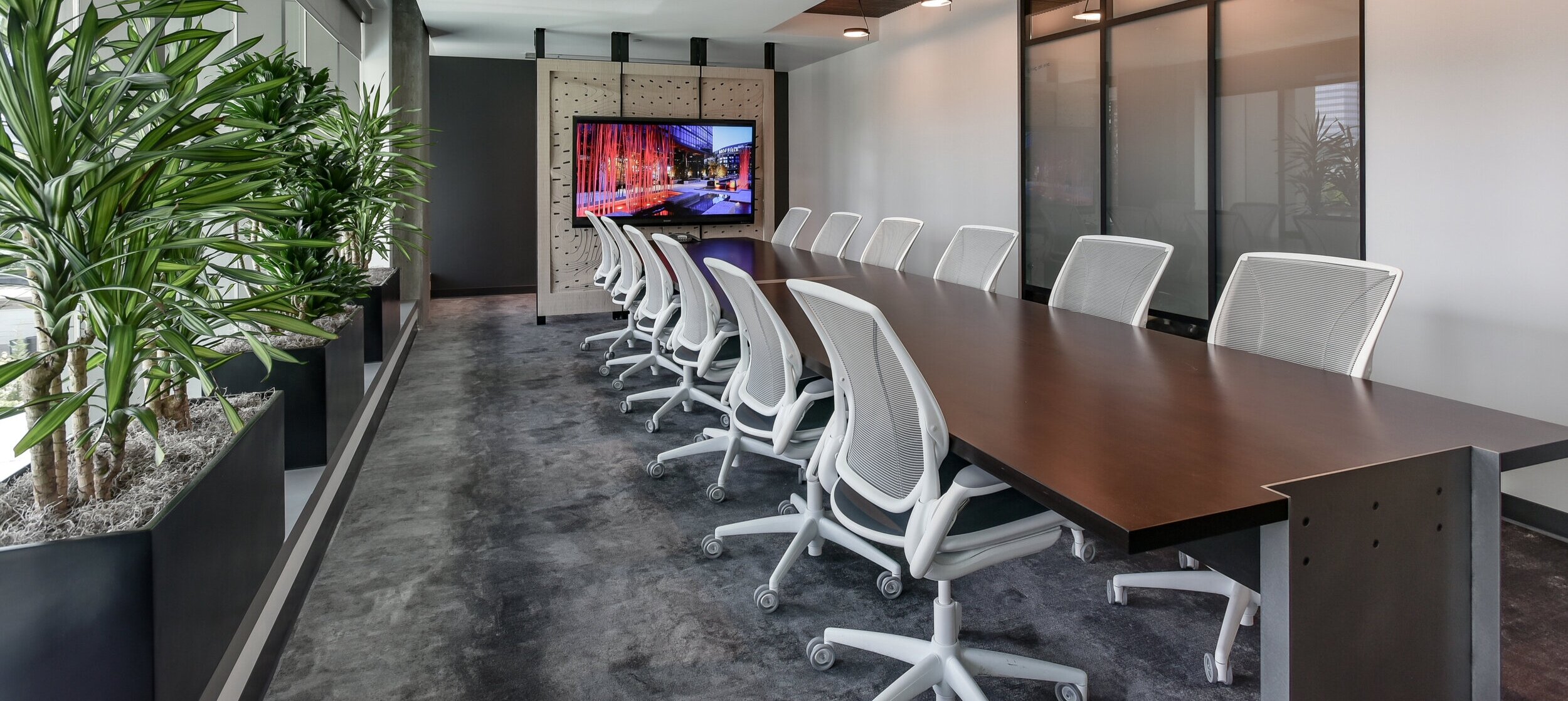 custom conference table with steel legs at the ends gives users plenty of leg room