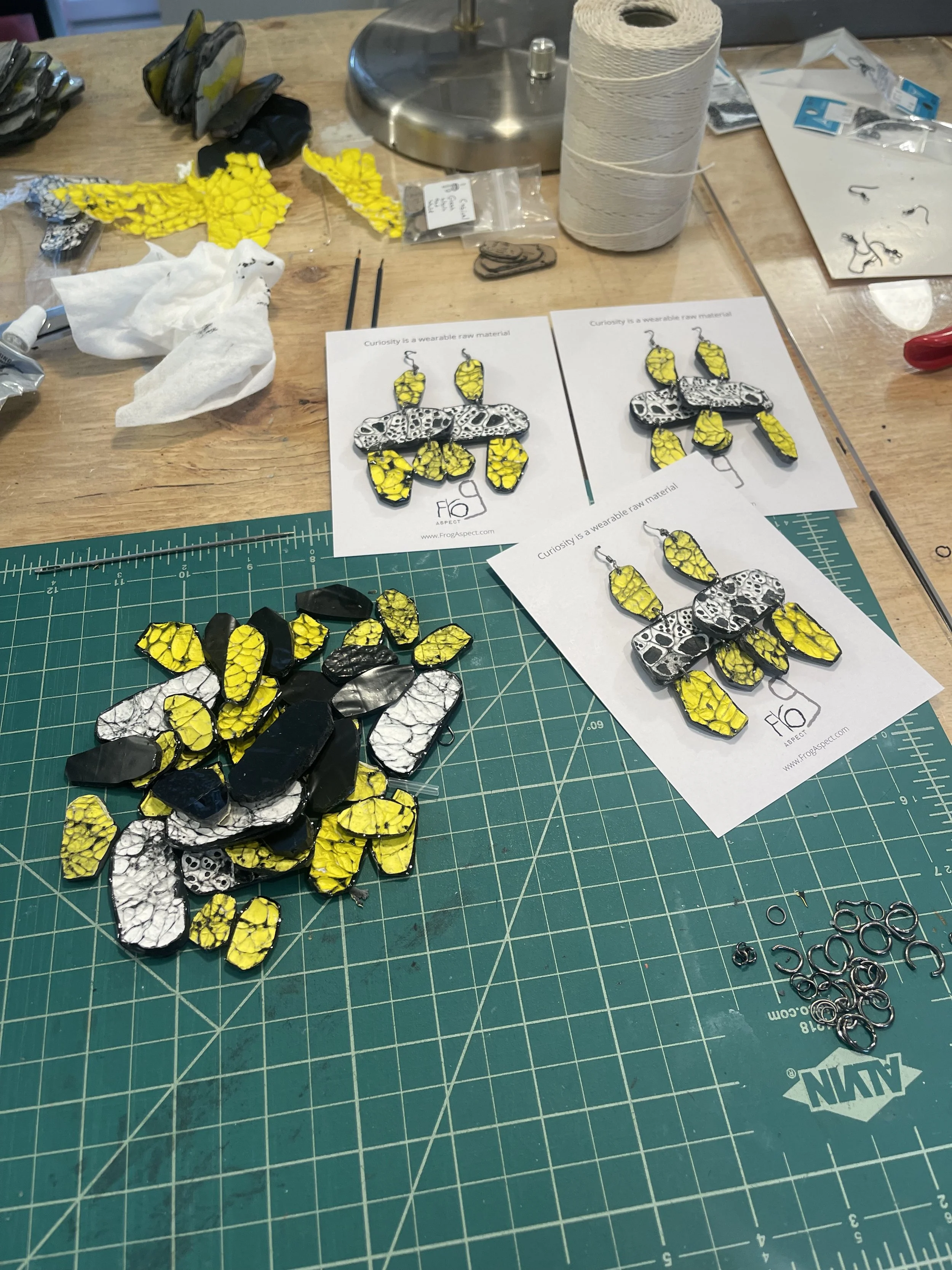 Finished earrings made from heat-manipulated cubic texture Tyvek and resin by Frog Aspect — handmade sculptural art jewelry Brooklyn New York