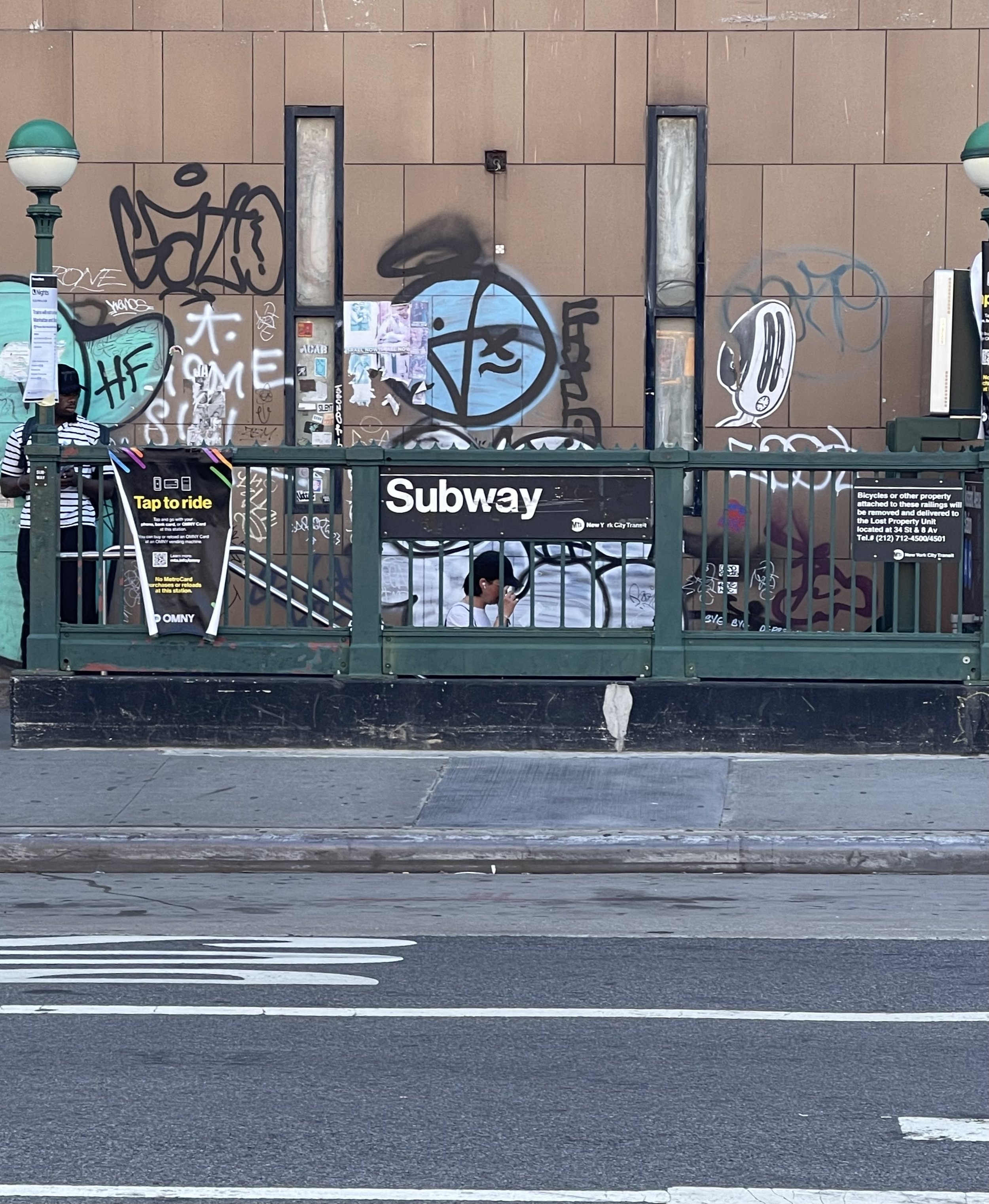 New York City subway entrance covered in graffiti — street photography from Brooklyn by jewelry artist Einat Cohen of Frog Aspect