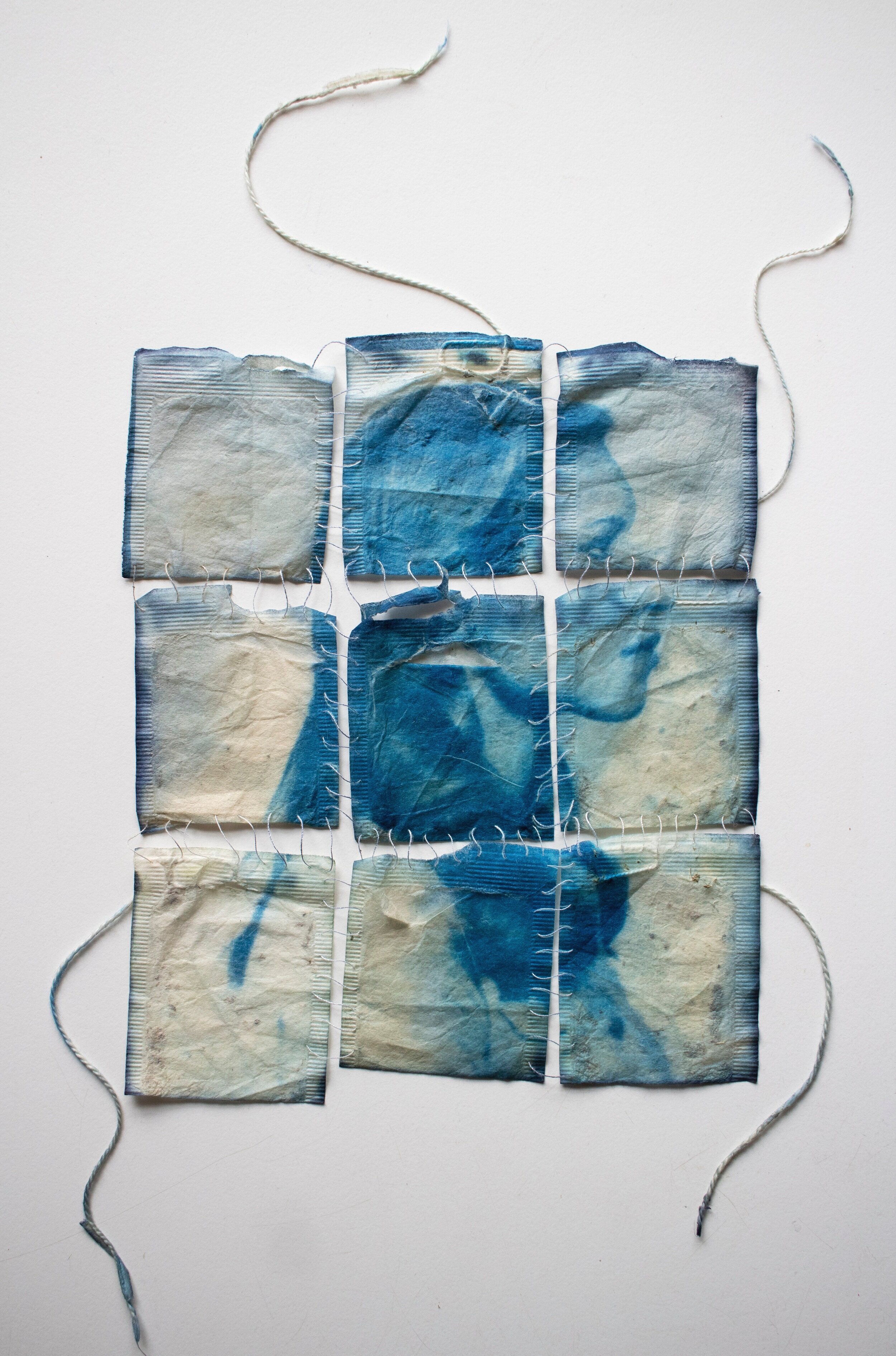    Lineage,   2021  Cyanotype portrait of my mother on the remains of her hierba luisa and manzanilla tea bags, sewn together with my grandmother’s thread 