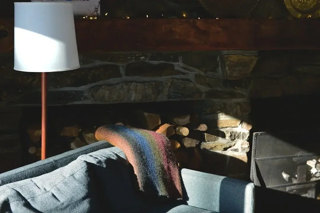 Cozy living room with a fireplace and warm lighting. Download the Holiday Body Talk Survival Guide for tips on navigating body image during the holidays.