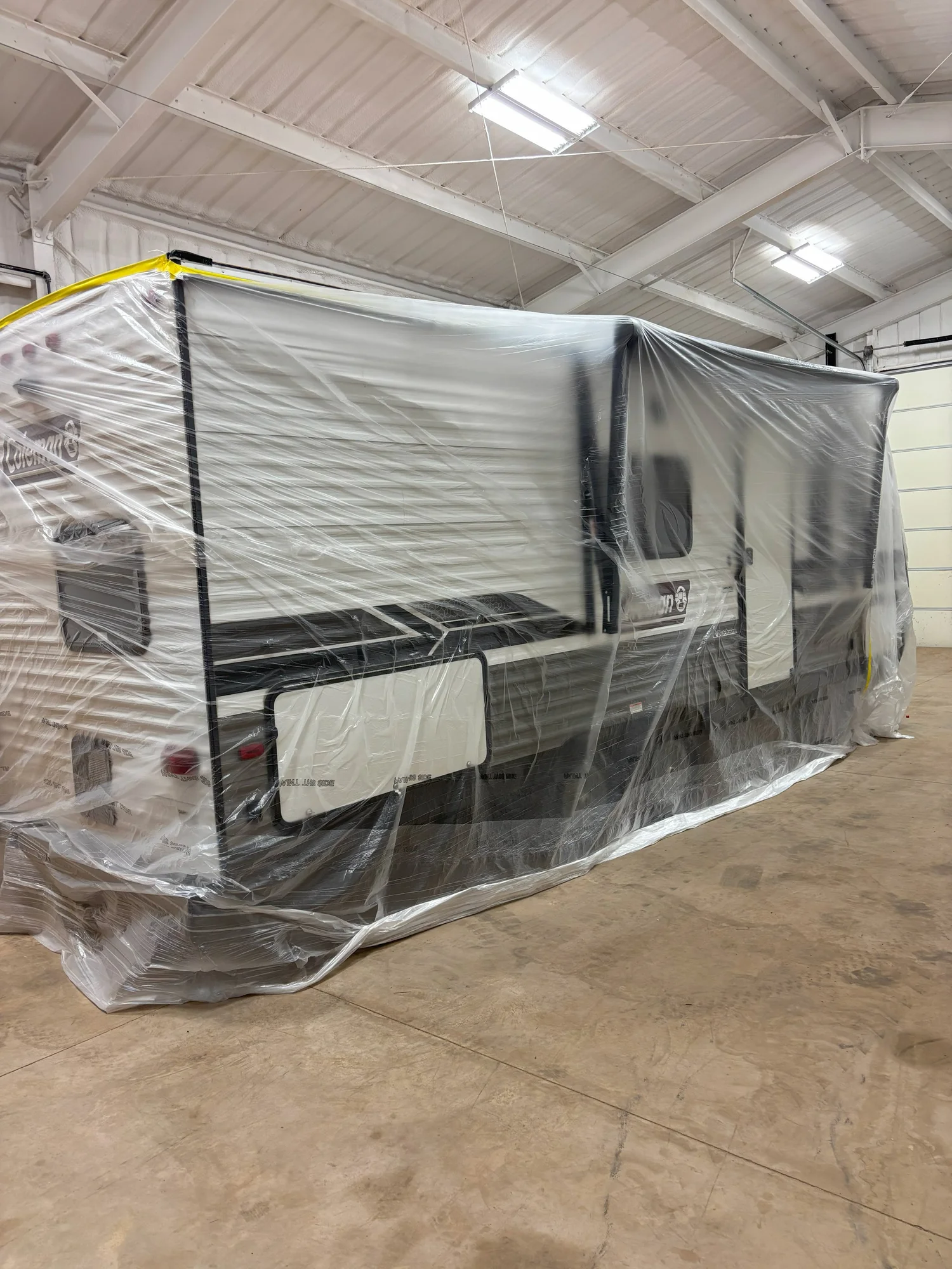RV protected and masked during professional roof preparation
