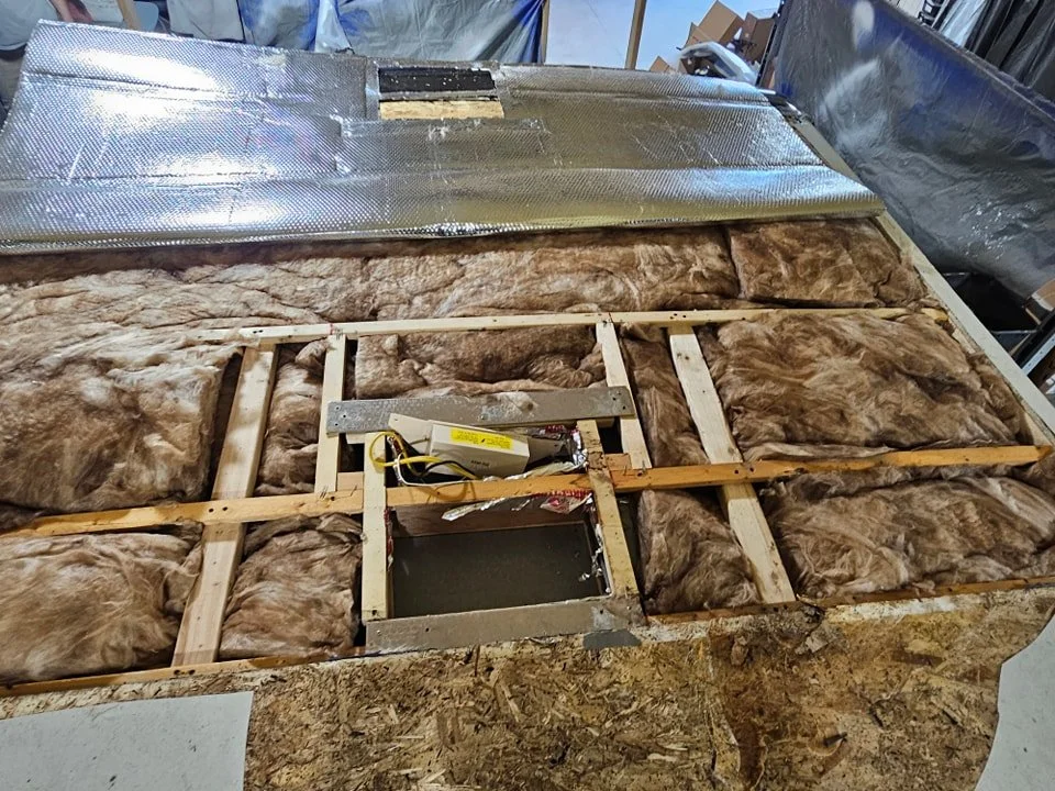 RV roof opened to expose insulation cavities during roof reconstruction