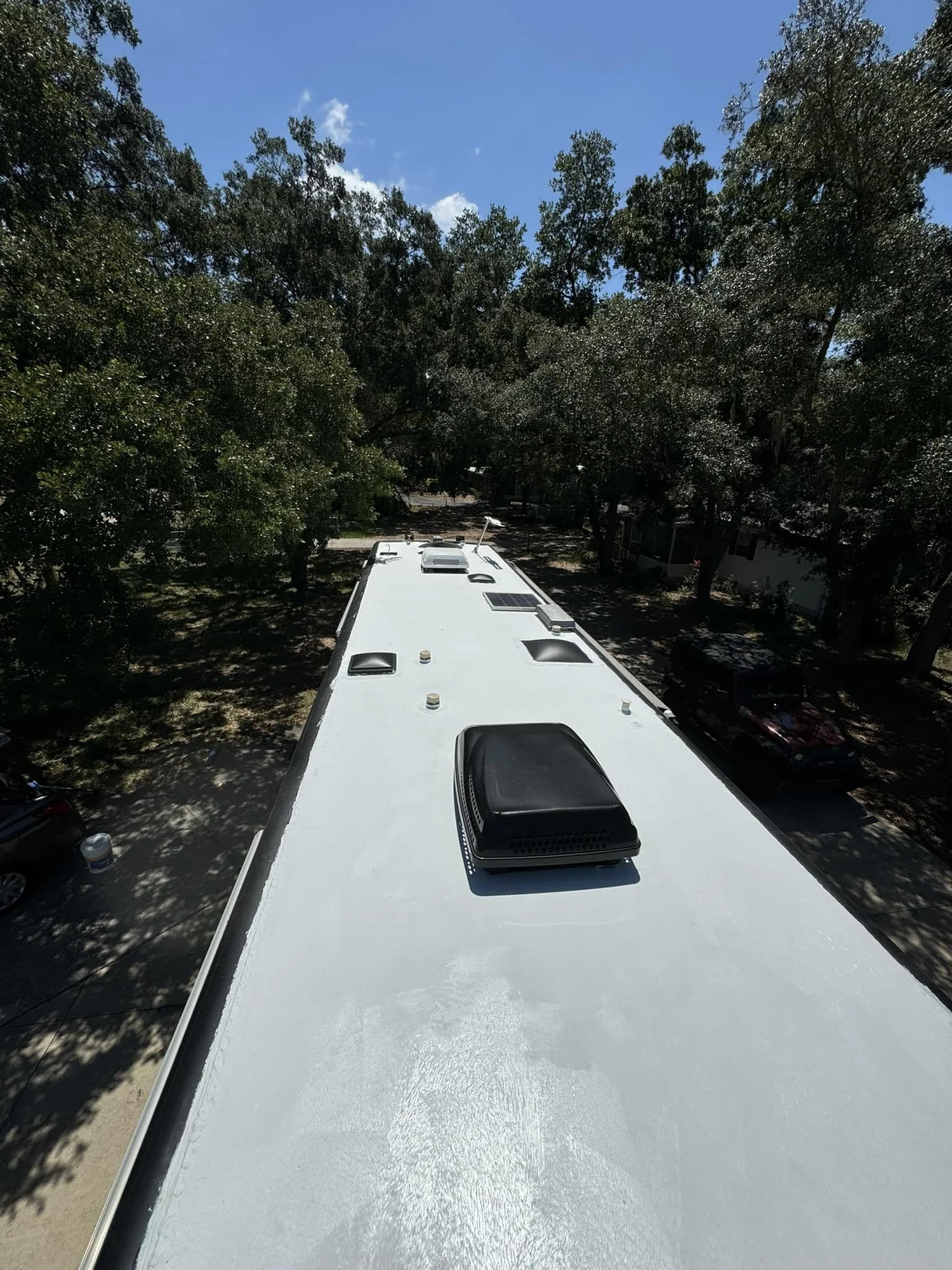 Finished white RV roof outdoors in bright sunlight