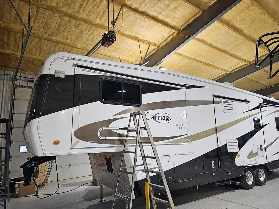 RV inside a professional roofing shop during roof replacement