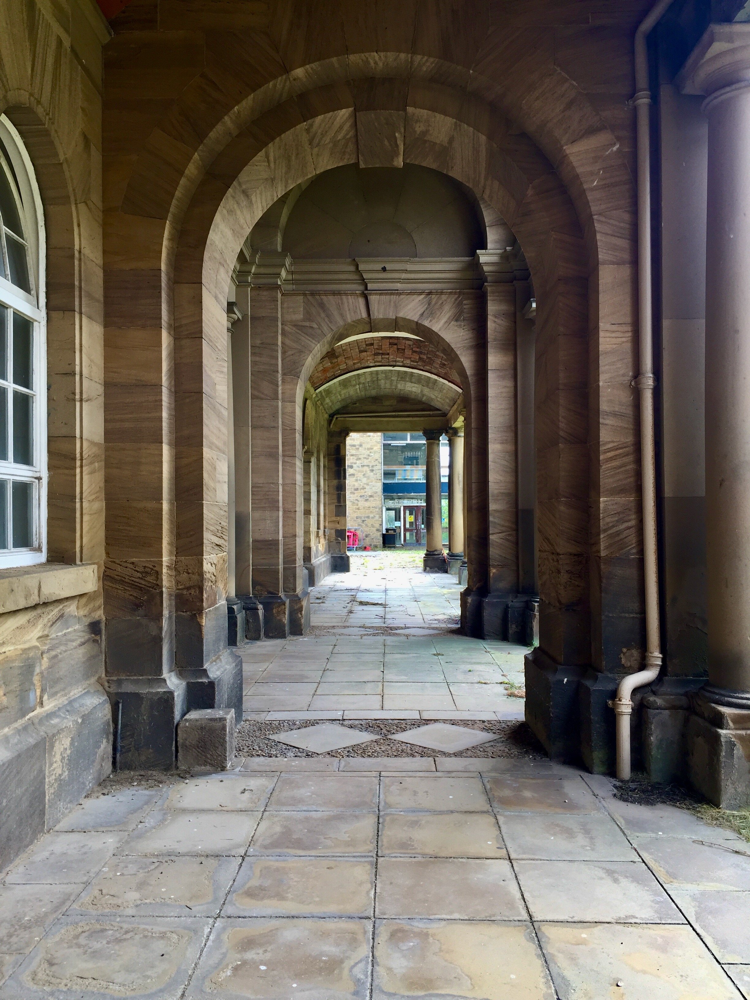  The original Stable Block walkway looks towards the early-60s library (and bin). 