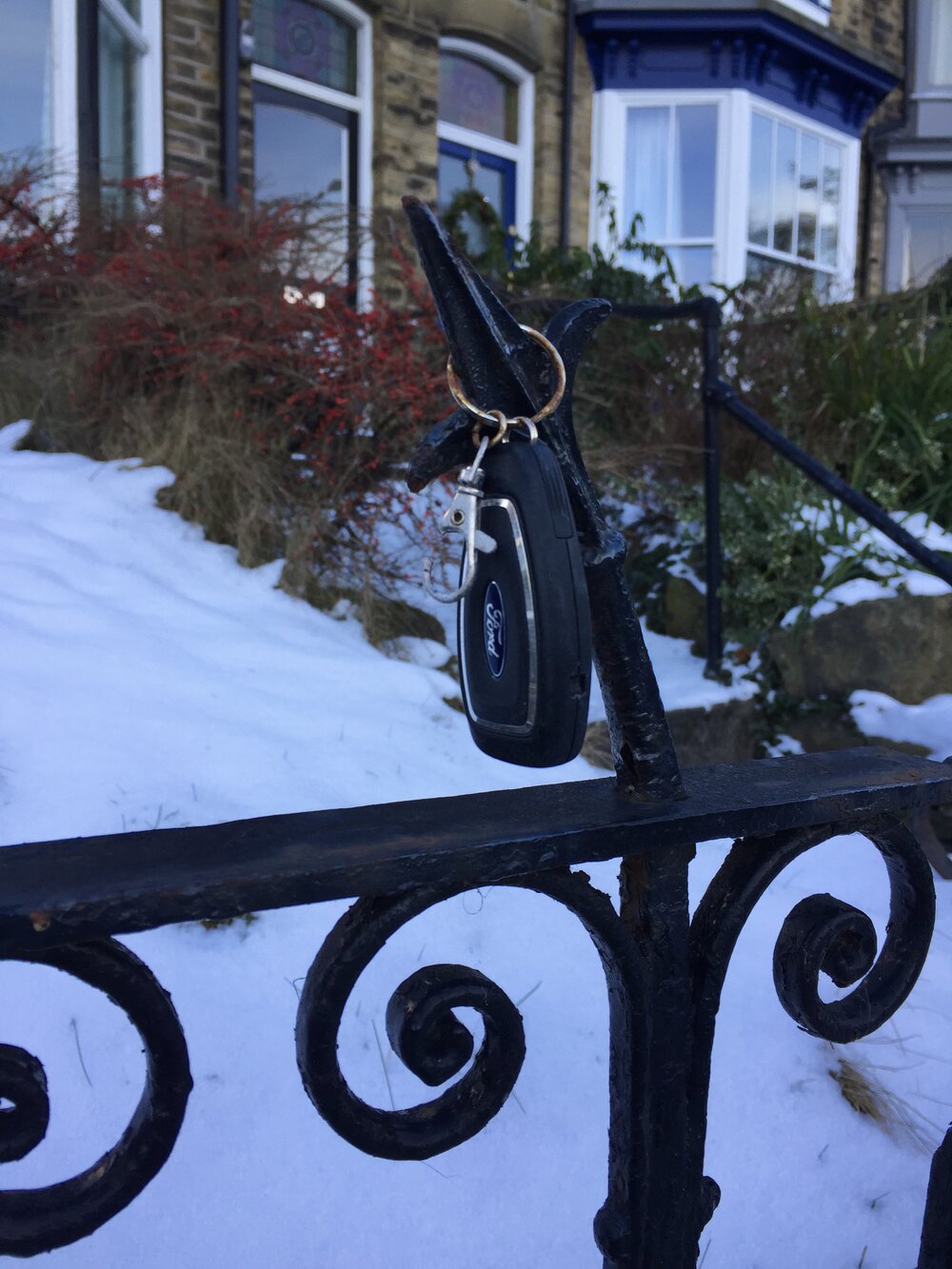  A car key on a key ring, mounted on the spike of someone’s front garden fence. The break in the clip probably reveals why this is here and not on someone’s person. 