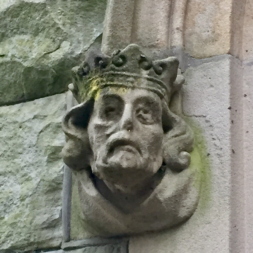 A stone head from one side of the main entrance: it looks like a crowned man, with curly hair and he looks somewhat forlorn. 