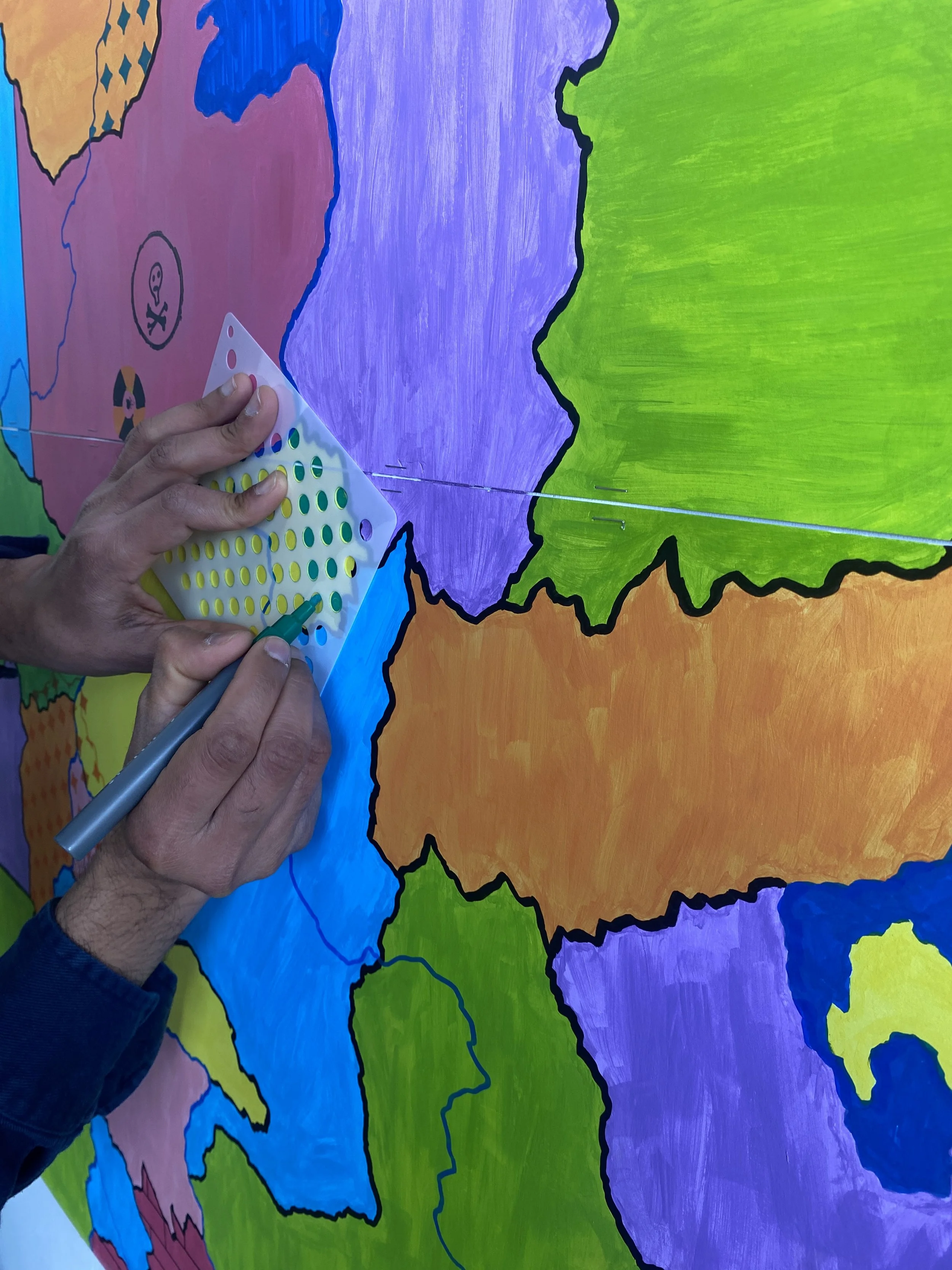  A man adds more pattern to the map, with the new nuclear exclusion zone visible to the left. 