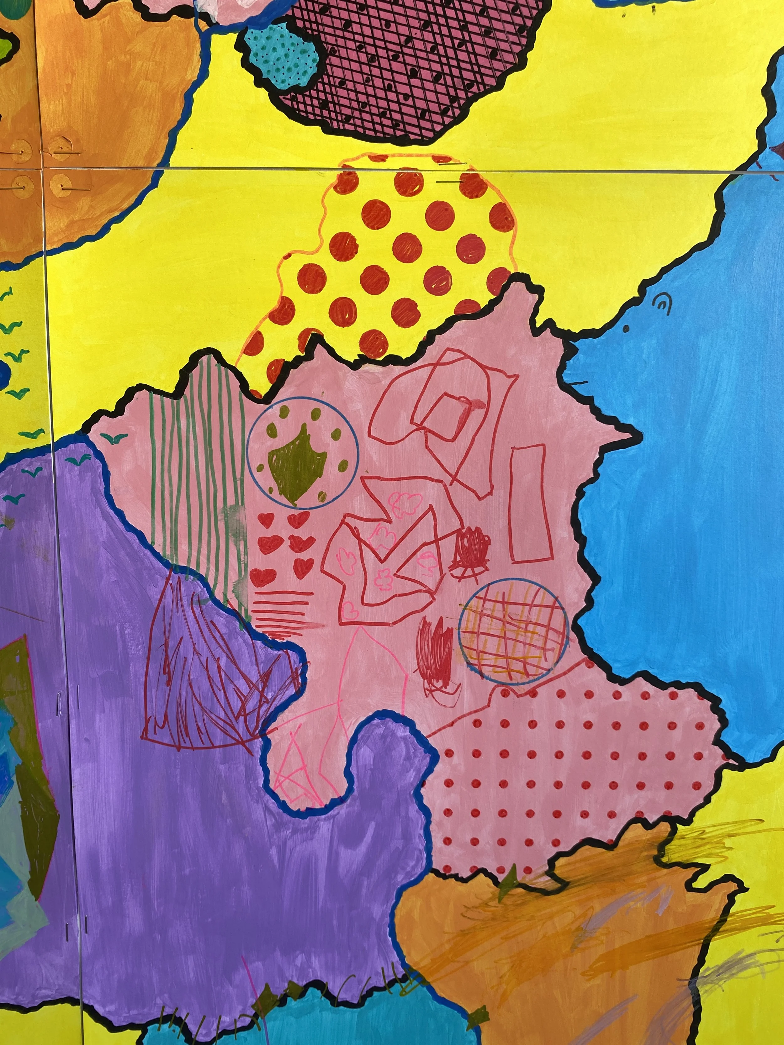  A close up of the symbols and drawings added by a girl. 